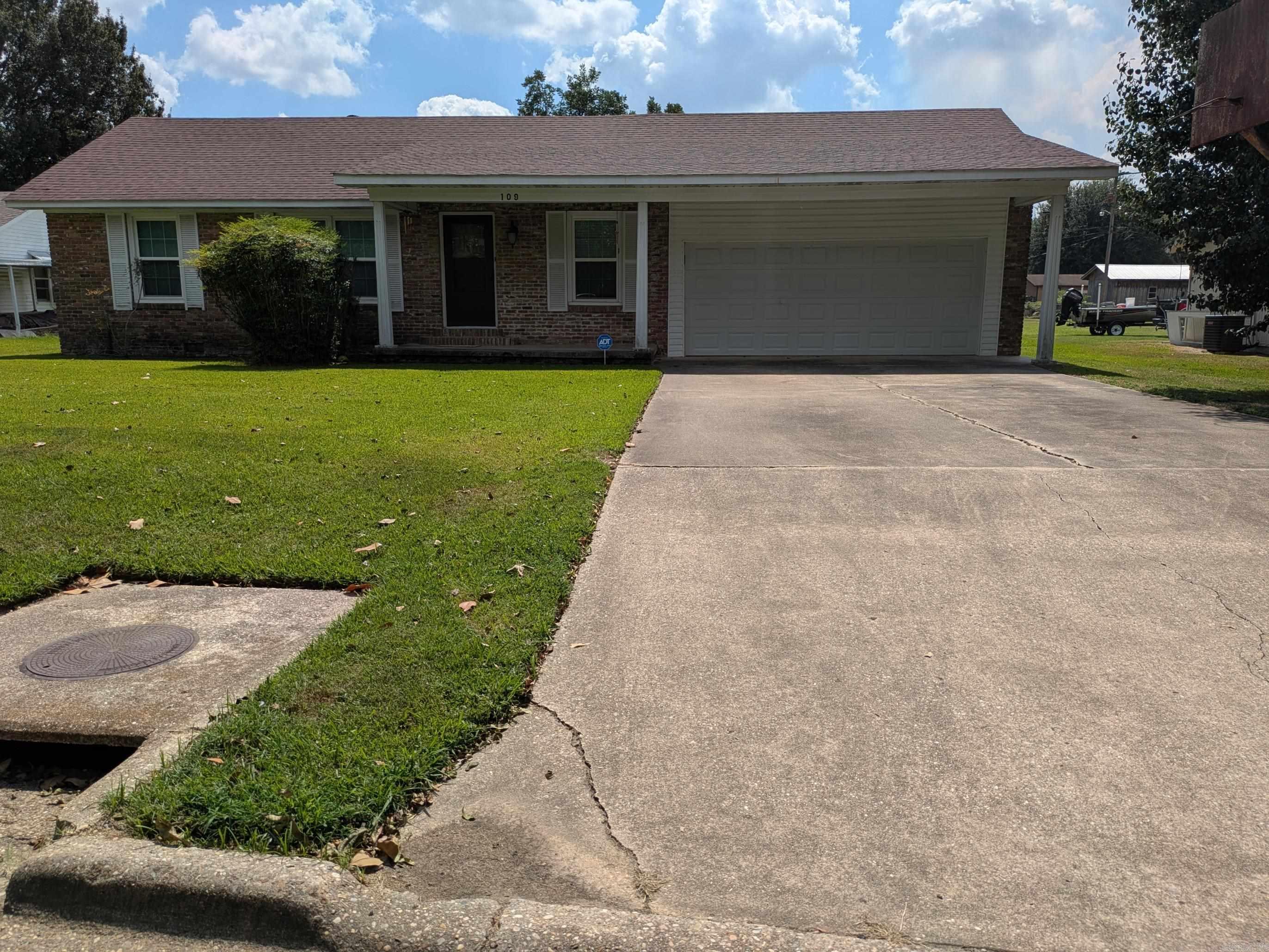 This beautifully renovated 2-bedroom, 2-bath home offers 1,695 square feet of comfortable living space with plenty of storage throughout. The spacious primary suite includes room for a sitting area and a large walk-in closet, while the second bedroom and full bath add convenience for family or guests. A welcoming front porch with classic white columns gives the home great curb appeal, and the two-car garage with storage closets is complemented by a wide concrete driveway. The huge backyard is fully fenced with chain link, perfect for pets or outdoor entertaining. Recent updates include a one-year-old architectural roof, new double-pane tilt-in windows, new interior and exterior doors with storm and security features, and patio doors with built-in blinds. Inside, pretty laminate flooring has been placed over the original hardwood, and new insulation plus a large floored attic provide additional comfort and storage. Stainless steel appliances stay with the home, and a security system with alarms on all windows and doors, also exterior lights that add peace of mind. This move-in ready home combines modern updates with classic style, making it a wonderful place to call home.
