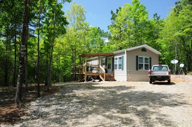 Cabin in the National Forest with garden spot. There are walking trails, spring fed pool with waterfall. Comes furnished and ready to move into. 10X12 deck, 12X20 porch. Vinyl floors, central electric heat with wall propane backups. 18, 500 BTU wall cooling unit. Propane tank conveys with property.