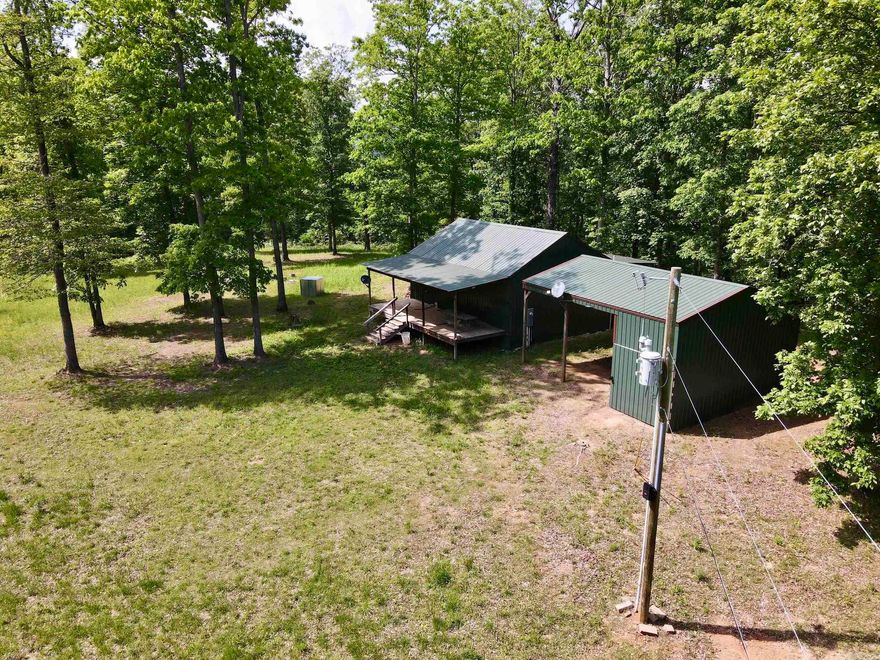 Properties like this are truly rare! Tucked away at the end of a gated Forest Service road, this charming 2-bedroom, 1-bath cabin offers the perfect combination of modern comforts and remote seclusion. With electricity, water, and Wi-Fi, you’ll enjoy the conveniences of home while being immersed in the tranquility of nature. Relax on the large porches at the front and back of the cabin, where the only sounds are the soothing flow of nearby creeks and the chorus of the surrounding forest. A pole barn provides ample storage for recreational toys or doubles as a pavilion for entertaining guests. Explore the property via well-maintained trails that lead to multiple creeks, waterfalls, and your choice of 5 strategically placed, high-quality box blinds for deer hunting. The landscape features mature hardwood timber, fields, and thickets that create a haven for abundant wildlife, including deer, bear, turkey, and even the occasional hog. Whether you’re hunting, hiking, or simply seeking a peaceful escape, this property offers unmatched opportunities to experience the beauty of the Arkansas outdoors. Don’t miss this rare opportunity to own a cabin retreat that truly has it all.