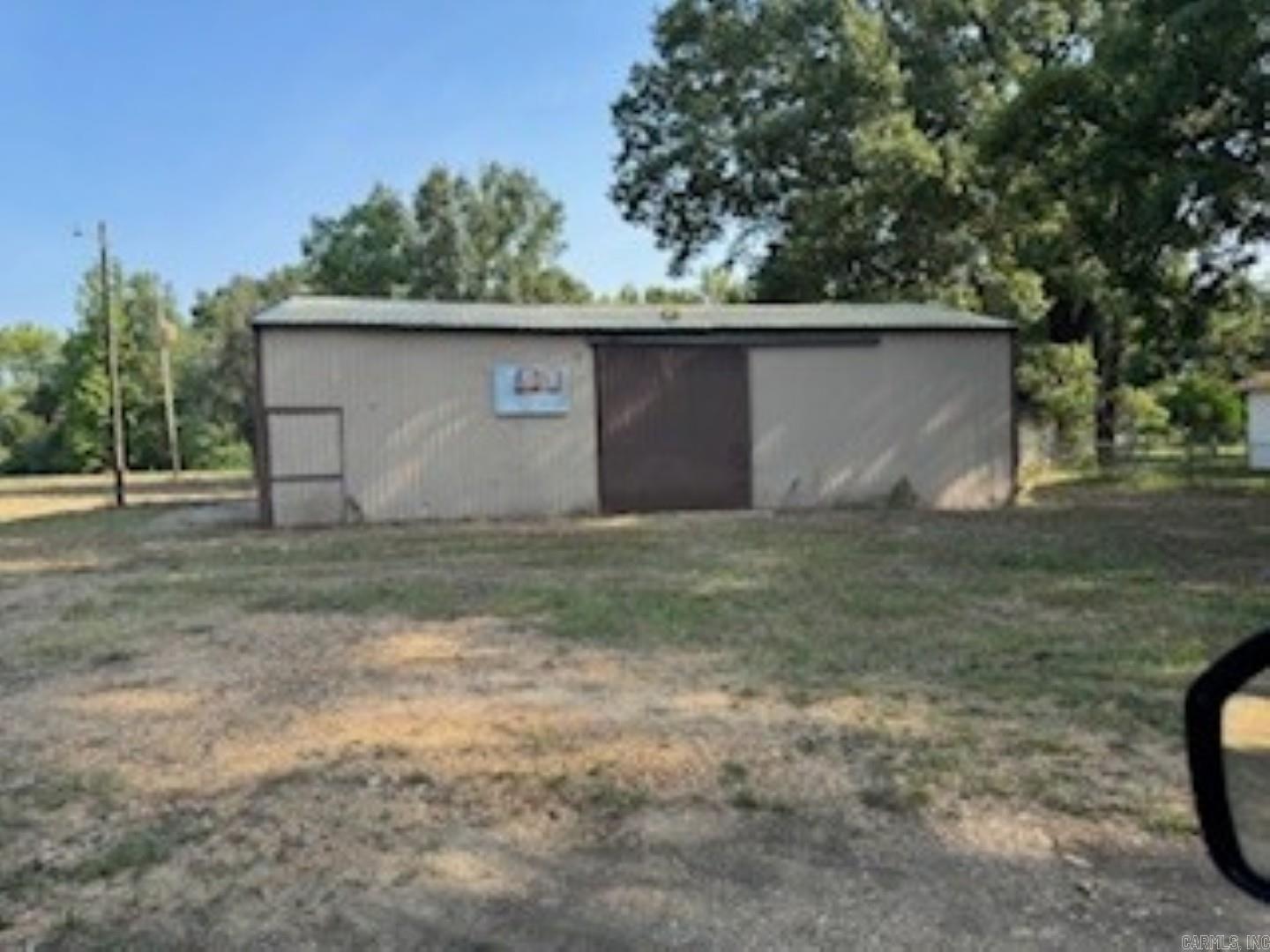 Situated in East Camden just minutes from the airport, factories, SAU Tech, and Harmony Grove School, this lot offers plenty of potential. Whether you're considering a mechanic shop, storage space, a home, or even a cool mancave, this level property has you covered. With roads on both the front and back sides, it's also an excellent option for a big truck driver.