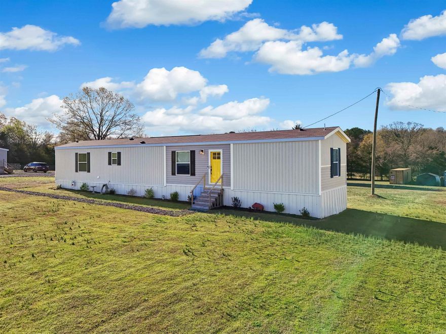 Back on the market through no fault of the sellers! This stunning 2024 Clayton single-wide, 3-bedroom, 2-bathroom home on a permanent foundation offers 1,100 sq ft of modern comfort on 2 serene acres. Built with all-new systems—septic, electric, water, roof, and HVAC—this property blends rural charm with contemporary finishes. Enjoy an open floor plan with sleek countertops, modern cabinetry, and stylish flooring. The primary suite includes a private bathroom, with two additional bedrooms for family or office space. Outside, the 2-acre lot features two new apple trees, two storage containers (one with electric), a carport, and an outbuilding perfect for a homeschool, she-shed, or studio. (Listing includes the single-wide and 2 acres, not the double-wide in the drone video.)