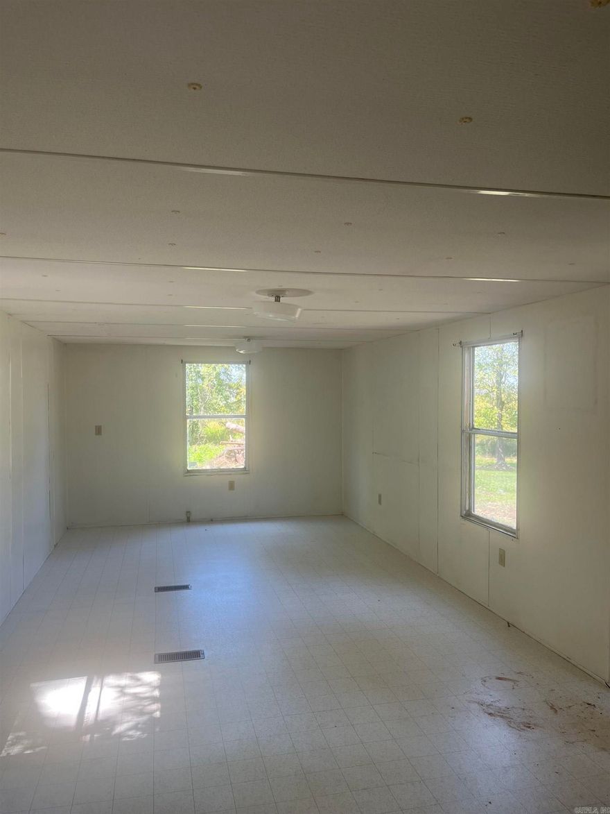 Don't miss this unique opportunity to own a lake lot with a two bedroom, one bath single wide mobile home !!! Located in a peaceful setting, this property is perfect for weekend getaways, full time living or as an investment. With the lake currently drained, now is the ideal time to build your dock or boathouse and customize your shoreline access before the water returns!! Seller is motivated and negotiable- bring your best offer!! Whether you're looking for a quiet escape or a place to launch your lake lifestyle, this property has incredible potential at a great price. New septic, new plumbing and a new power pole!!