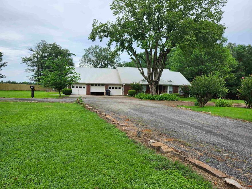 Spacious one level home conveniently located. Level 2.5 acres. Home has 3 bedrooms and 2 full baths. 2,118 square feet. Large Family Room with vaulted ceiling. Separate room off formal living room can be 4th bedroom or private office. Formal Dining Room, Nice Kitchen with lots of storage space, pull out drawers under the Gas Cook top for easy access, Wall Oven, Pantry, Dining area with breakfast bar. You have 2 entries from the 3 car garage into the house, one leads to the laundry room, and one opens into a generous size tile floor mud room off the primary bath area. This makes it so easy to get out of your muddy, dirty things and shower before entering the main part of the home. The 4th attached garage is a perfect place to park your lawn equipment or work on your projects. New Air Unit installed in 2023, New Septic System installed in 2022, Additional Insulation added by Terminix in 2022, New Water Heater installed in 2020. New whole house Generator installed in 2020, Metal Roof installed in 2016. Propane Tanks are owned. Concrete Storm shelter. Large covered patio. Schedule your private showing today. Square footage is approximate, please measure. Agents see attached documents.