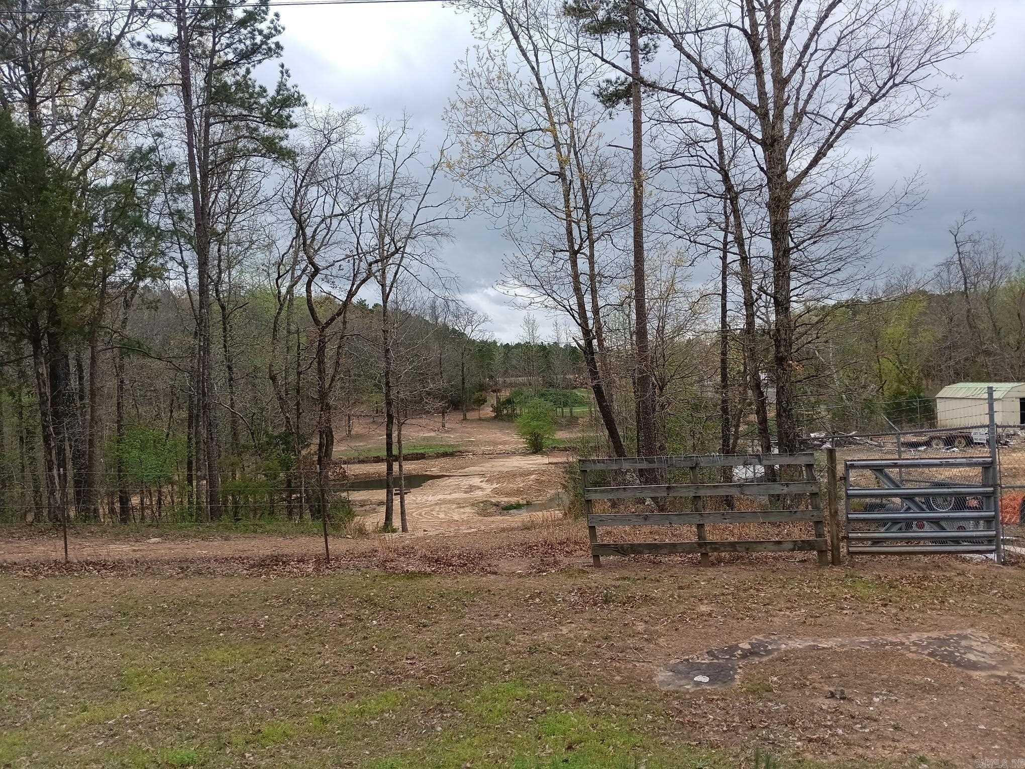 15 acres on paved county road just a few miles from Rosebud & less than 30 minutes from both Searcy & Heber Springs. Previously an off-road riding course & a wrecker service & can be used as commercial, hobby farm, residential or recreational land. It has a small 480 sf cabin, storage buildings, storage canisters, old mobile home & shop on property. Property is fenced. No owner finance. See agent remarks.