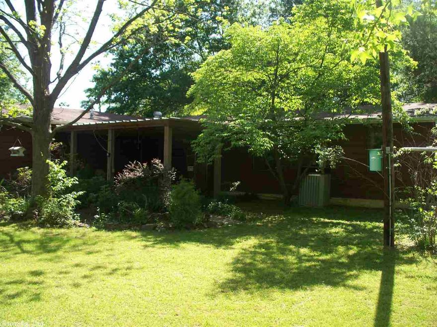 Great Location with huge yard.... Home is seated on one lot with another attached lot behind the home... Three Bedrooms and Large bathroom, Two Large living areas, Two Car Carport... One Owner Home... Fenced... Storage building in back yard.  Great Solid Home!!