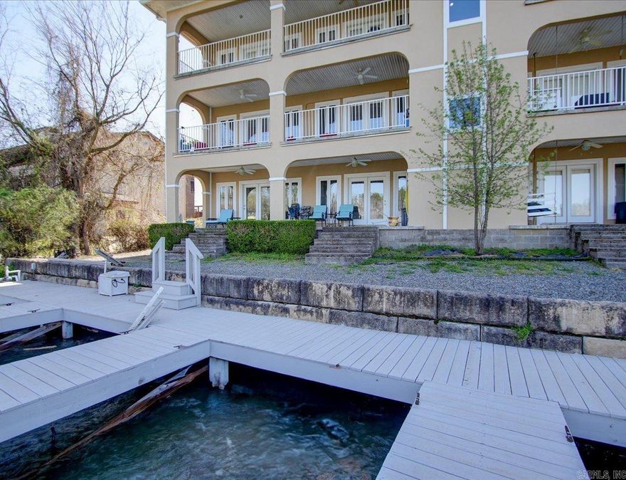 Don't Miss this Fabulous 3BR/3.5B, Lakefront Condominium.  Gated, Swimming Pool, Double Car Garage (no door), Boat Slip, Two Large Covered Rear Porches, Tiled with Ceiling Fans and Incredible Views of Main Channel and Sunset! Inside the Floor Plan is Excellent.  Walk-in from Garage to Den/Game Room, Powder Room and Large Bedroom Closet and Bath.  Upstairs is Wonderful!  Giant Living/Dining and Kitchen Area with Beautiful Flooring, Granite and Stainless Appliances,  Master Suite and 3rd Bedroom with Bath.  All Closets are Gigantic, Immaculately Maintained, Outdoor Storage.  Square Footage Makes this Live Like a Large Home with Guest's Quarters.