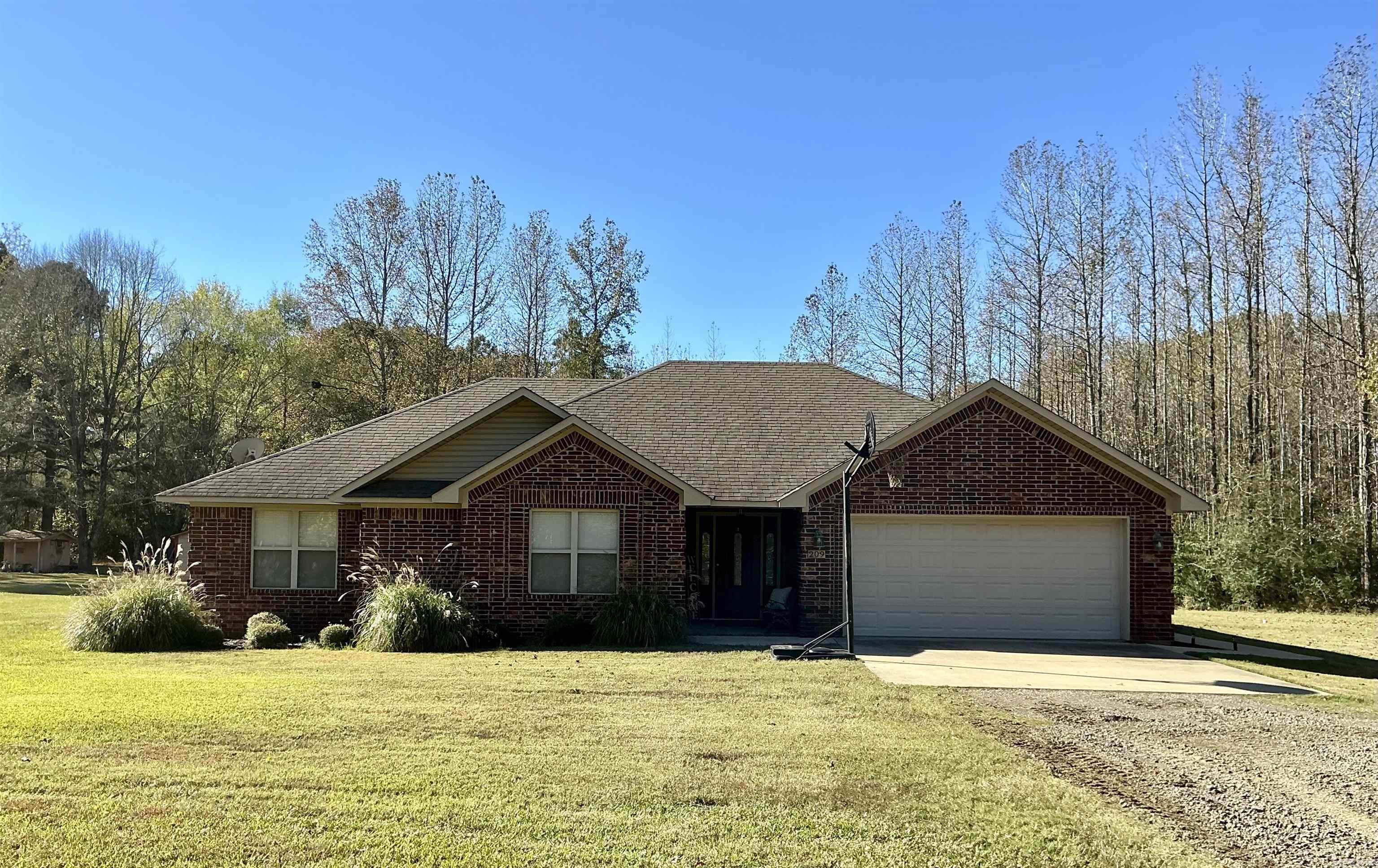 Enjoy 3 acres of tree lined privacy as a beautiful backdrop for this charming all brick 3 bed/2 bath home outside the city limits! Relax by the fire pit, soak in the hot tub, or watch nature out your back door. Home features master bath with walk-in shower and soaker tub, walk-in closets throughout, and a spacious living area. There is a nice storm cellar and 12x20 shop with electric on the property. Plenty of room to park the boat, camper or plant the perfect garden. Escape the city and enjoy the amenities of country life!