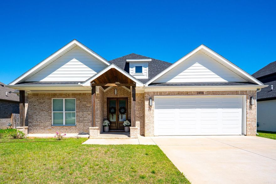 Built in 2023, this 3 bedroom, 2 bath home features an open split floor plan with a light, bright feel throughout! A large, welcoming foyer greets you at the entrance, and a cute covered back porch provides the perfect spot for relaxing. The kitchen offers a large island with extra storage, cabinets to the ceiling with glass display doors at the top, granite countertops, gas range, and stainless appliances. It opens to a spacious living area with a gas fireplace. The spacious primary suite includes a bathroom with granite countertops, double sinks, a soaker tub, separate walk in shower, and a roomy walk in closet.