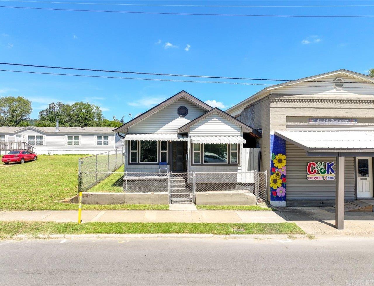 LIVE, WORK, OR INVEST - THE CHOICE IS YOURS! 2 PROPERTY DEAL, 1 MINUTE TO DOWNTOWN HOT SPRINGS and Historic Central Avenue—right in the middle of all the action! Enjoy easy access to Bathhouse Row, art galleries, shopping, restaurants, the Convention Center, parades, festivals, and more! Biking and hiking trails are just minutes away! This unique property package includes a 3 bed, 2 bath single family home with 1,167 SF plus a versatile 1,100 SF commercial building next door — offering flexibility for your lifestyle or investment goals. Whether you're looking to live in the home and launch your dream retail or office space next door, or want to create dual rental income streams, there are many possibilities. The commercial building has a half bath and open layout perfect for a boutique, gallery, studio, or small business. The home has a comfortable layout and a fenced yard for privacy or pets. Both properties sit side-by-side, allowing for easy access while maintaining separation for work-life balance or tenant use. Rare opportunity for a residential and commercial building at this price point! Come and see! Agents - please schedule all showings with Showing Service.