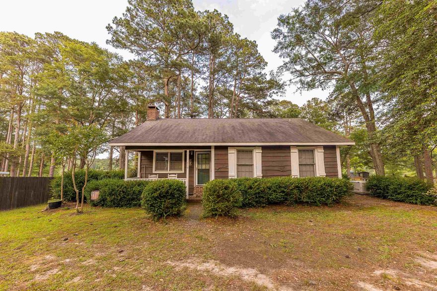 Tucked along the peaceful shoreline of Lower White Oak Lake, this charming cottage is full of curb appeal and character, offering the perfect match of comfort and outdoor living. Situated on a rare double lot, the property provides space, privacy, and easy, direct access to the water—ideal for weekend getaways, or full-time lake living.  Step inside to find warm hardwood floors that add timeless appeal, while the flow of the floor plan invites natural light and serene lake views. The home is move-in ready, complete with a refrigerator and electric fireplace insert, and the added peace of mind of a newer roof and a backup whole-home generator.  Outdoors is where this property truly shines. A private boathouse and dedicated fishing dock make it effortless to enjoy early morning casts or sunset cruises. Entertain or unwind on the inviting brick patio and covered porch, accented by beautiful flagstone pavers and a classic stone wall that enhances this cottage’s unique personality.  Whether you're seeking a relaxing retreat or an inviting spot to host family and friends, this lakefront gem offers charm, convenience, and a lifestyle that’s hard to match.