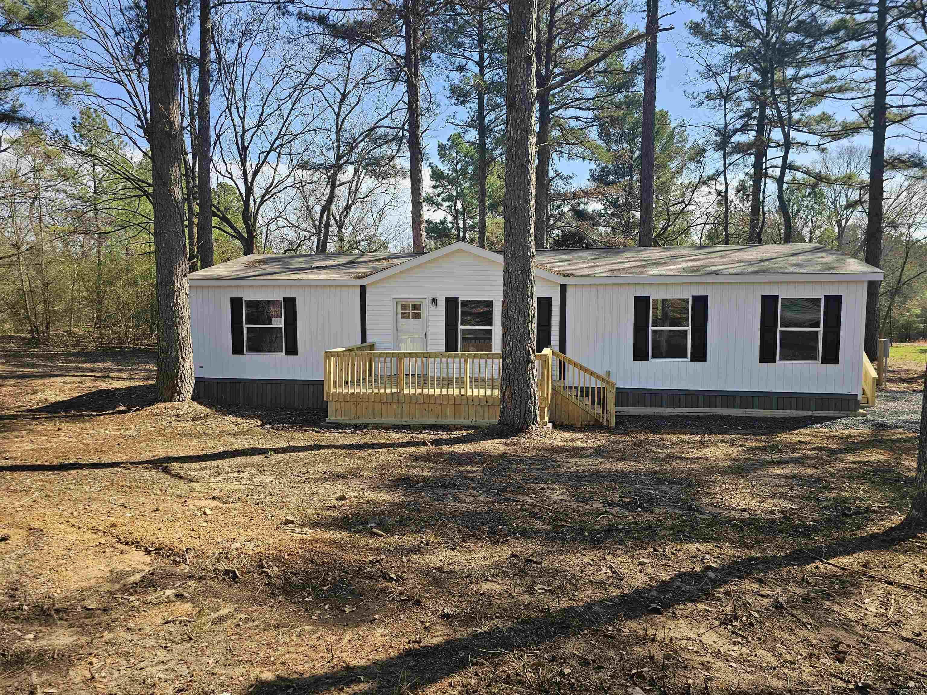 Brand new mobile home on a permanent foundation located outside of the city limits. The home is beautiful and has an open floor plan. There are 3 bedrooms with the master apart from the 2 guest rooms. The kitchen is beautiful with lots of cabinetry. There is also an island that is perfect for additional prep space or entertaining. All of this and it's situated on 1.41 acres. Call today for a showing.