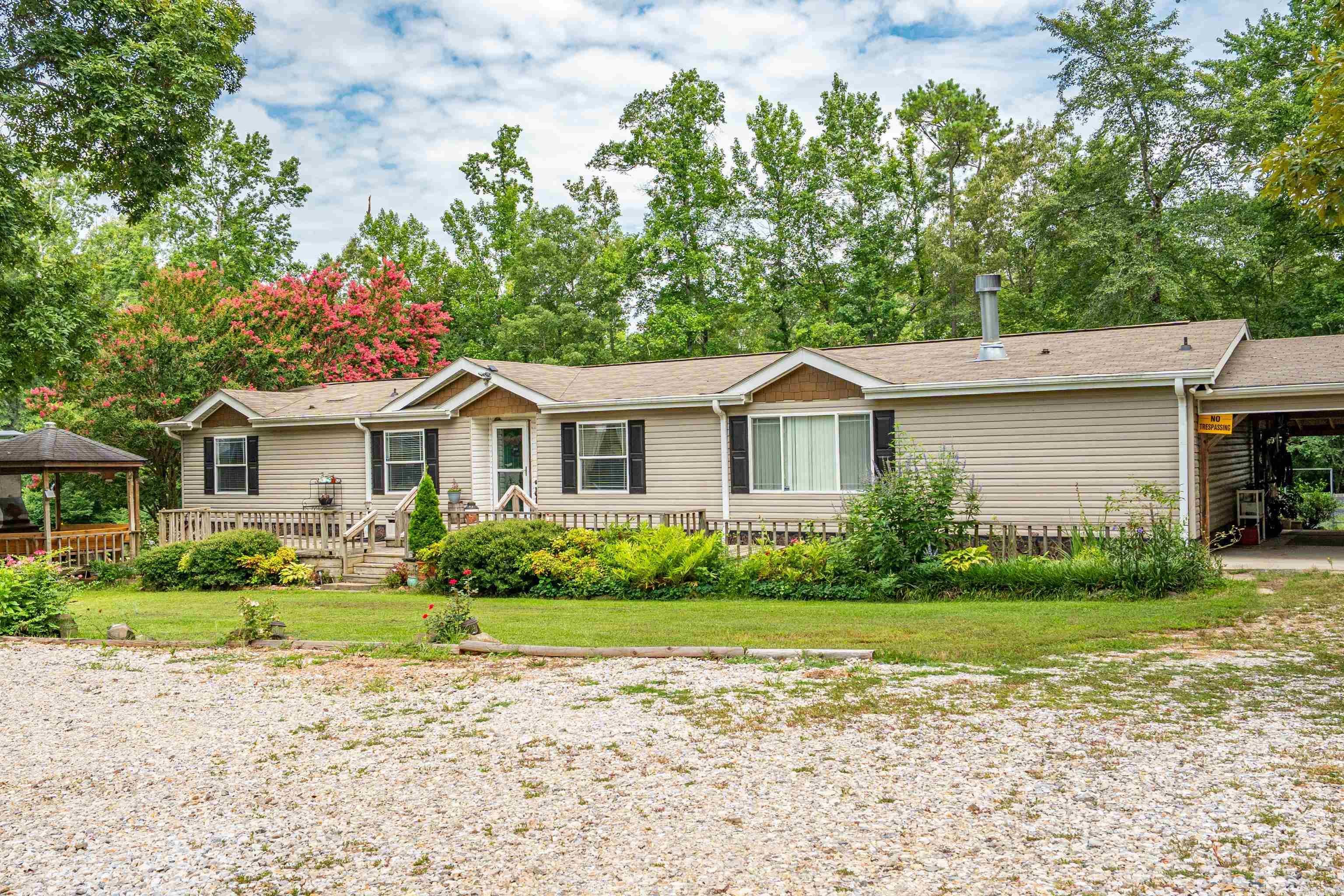 This is a true Family Retreat. The property was built with multi-generations in mind or it would be perfect for income producing property too. The main house is a 3 bed/2 bath double wide on a permanent foundation. Here is a list of extras: roof 6yrs, new water heater, windows 2018, new LVP flooring, above ground pool, screened in porch & a propane tank for the wall heater in case the electricity goes out. The tiny house next door is 888 SF...open floor plan, granite countertops, new septic, 2 bedroom, 1 bath, & laundry. This was built as an in-laws suite. There is even a ramp to the front porch, carport & shed. There is another building 160sf currently being used as massage studio complete with a toilet & sink, and loft bed. Perfect for a small business, "she" shed, or guest. There is another 312sf bldg currently being rented for $550. RV parking carport with full hookups. Come see this unique & beautiful property.