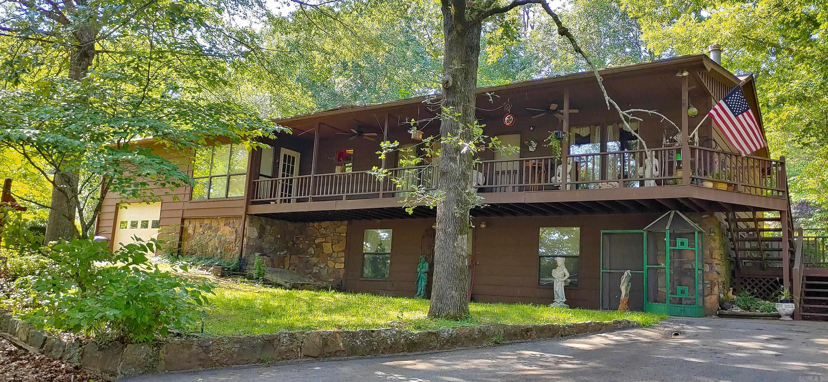 A hidden chapter awaits just minutes from the shimmering shores of Greers Ferry Lake. This house is nestled on a quiet street. A second detached garage, already equipped with water and electric, is ready to be transformed into a creative studio, workshop, or private retreat. Inside, you’ll find rooms full of character, a main-floor bedroom with potential for a third bath, and an attic just waiting to be rewritten into a cozy living space. Whether you're dreaming of a lakeside escape, a short-term rental, or your own storybook home, this property is brimming with promise. Sold as-is. Come write your next chapter here
