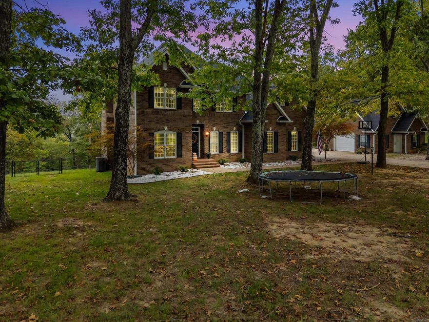 Experience refined lake living in this estate-style custom home, thoughtfully designed across three levels of elegant living space. Nestled on 2.47± acres bordering the government strip, this 4-bedroom, 3.5-bath residence with a dedicated office offers serene winter lake views and a gentle, usable slope. A matching detached garage/shop provides guest house potential, complemented by an additional 2-bay shop for ample storage. Inside, you’ll find timeless craftsmanship—hardwood floors, a gourmet kitchen with granite surfaces, gas-log fireplace, and central vacuum system—creating a perfect blend of comfort and sophistication.