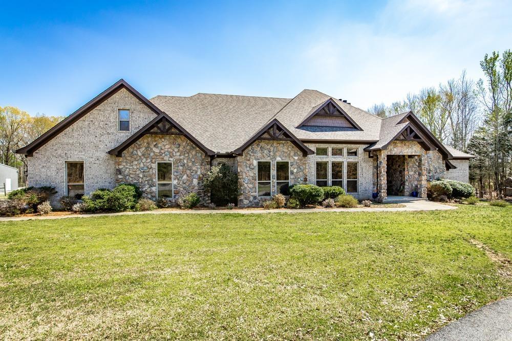 Come home to this gorgeous country estate on 18 acres, already set up for your animals! This luxuriously appointed home allows for you to live your homesteading dreams while still enjoying all the creature comforts! 12-foot ceilings, beautiful hardwood floors and granite countertops throughout. Primary suite boasts its own private fireplace, tray ceilings, a custom walk-in double shower as well as a 2-person jetted tub along with a massive closet. Each bedroom has its own en-suite bathroom, giving each member of your family their privacy. F-4 tornado rated safe room off the kitchen than can double as a home office or study with barn doors. Mud room entry from garage and large laundry area. Kitchen includes double convection ovens, under counter ice maker, and instant hot water dispenser at the sink. 3 separate HVAC units and 2 water heaters (80gal and 50 gal) to keep everyone in this home happy and comfortable! New roof installed in 2023! Fenced back yard for pets, large covered patio for entertaining or relaxing, 3 stall barn with attached paddock and riding arena along with separate pasture area with solar electric fence.