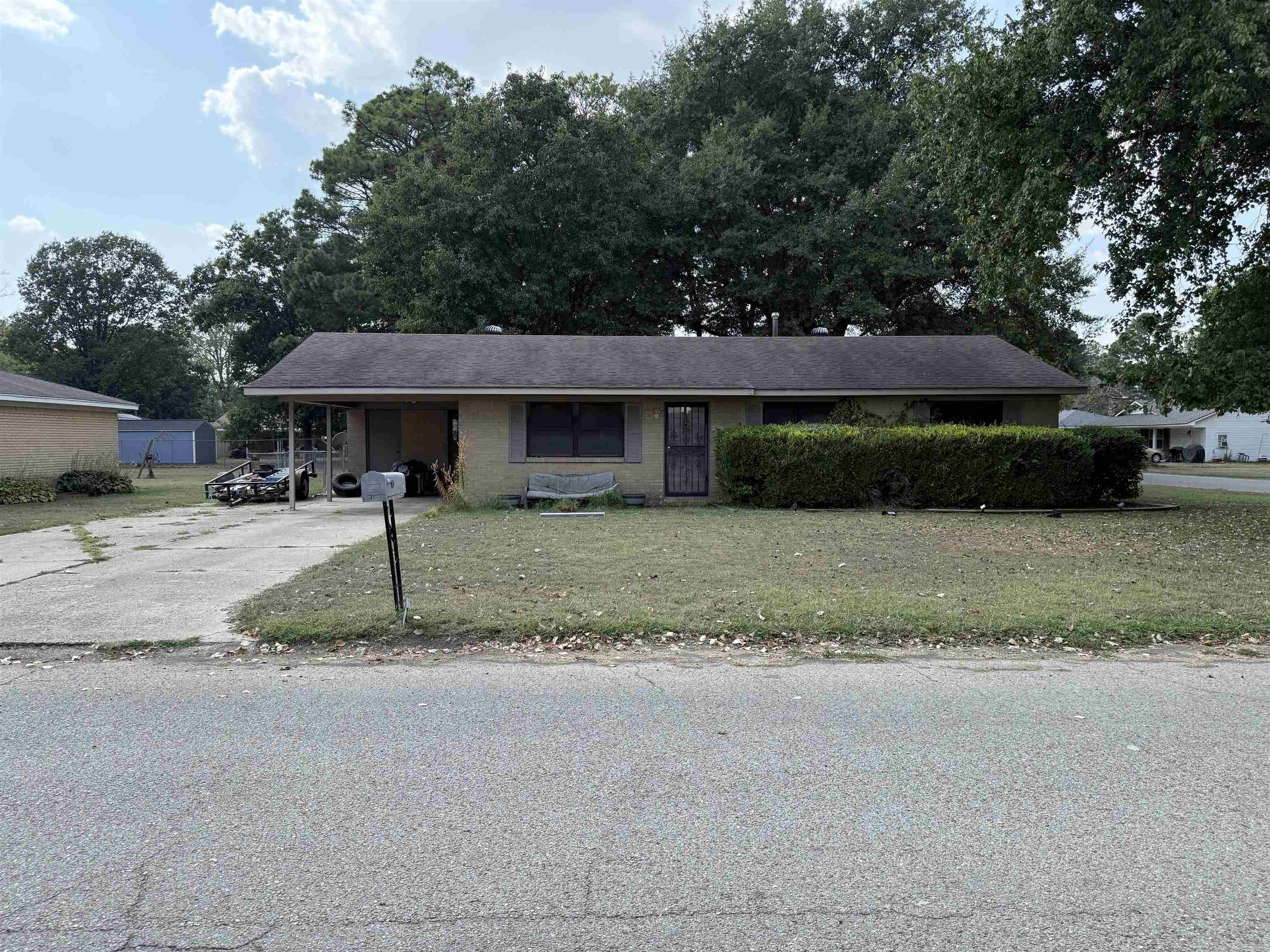 This charming 3 bedroom, 1 bath home sits on a spacious corner lot and offers solid potential for a variety of buyers. The interior provides over 1,200 square feet with a practical floor plan that includes a comfortable living area, functional kitchen, and three bedrooms. A covered carport adds convenience and protection from the elements. The exterior features are a highlight, with a large fenced backyard that provides ample space for pets, play, or gardening. A covered patio adds additional outdoor living space, making the yard usable year-round. The property is being sold as-is, presenting an opportunity for updates, customization, or investment.