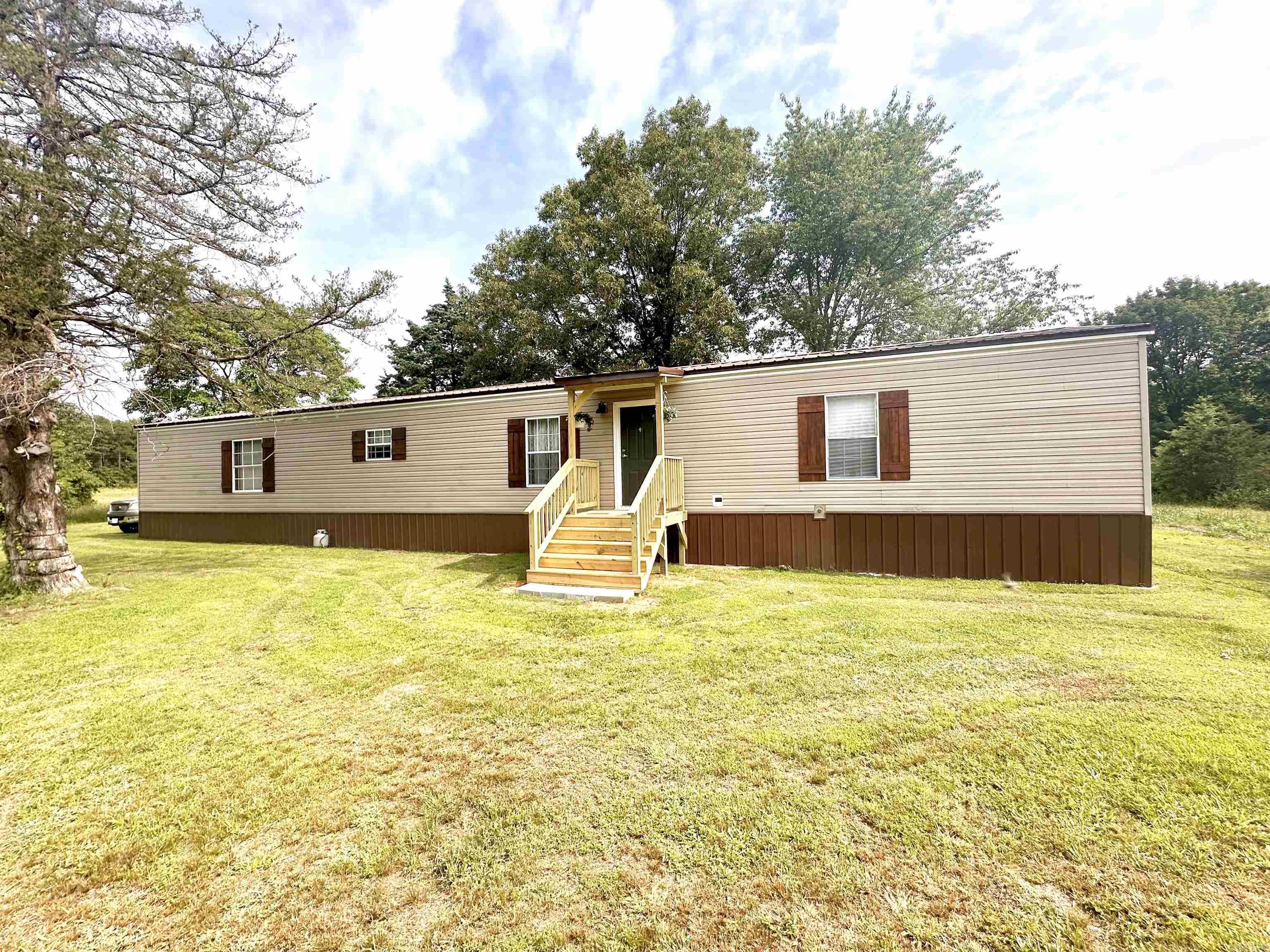 Remodeled single-wide mobile home on 5 acres in the country. No restrictions so you can bring your animals! Peaceful setting with room for everyone - 3 bedrooms 2 full bathrooms. Remodeled to include new roof , new mini split systems and water heater, new flooring throughout, neutral paint colors, updated tastefully done kitchen with tons of room for cooking with a coffee bar area, updated bathrooms, and a new septic tank. Home has tie downs on piers. Two sheds in the backyard for storage, one shed has been made into a home office. Exact boundaries of 5 acres to be determined by new survey.