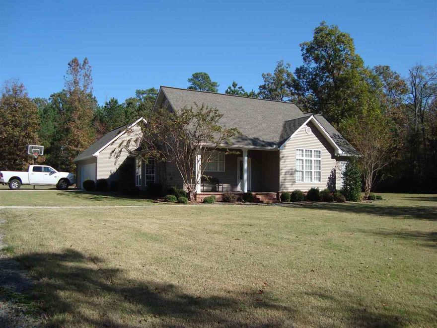 Very nice and well maintained home nestled on 4 acres. Hardwood floors throughout, 3BR/2BA, large attached garage, covered rear porch, and 864sf shop building that matches the house construction. Country living at its best!