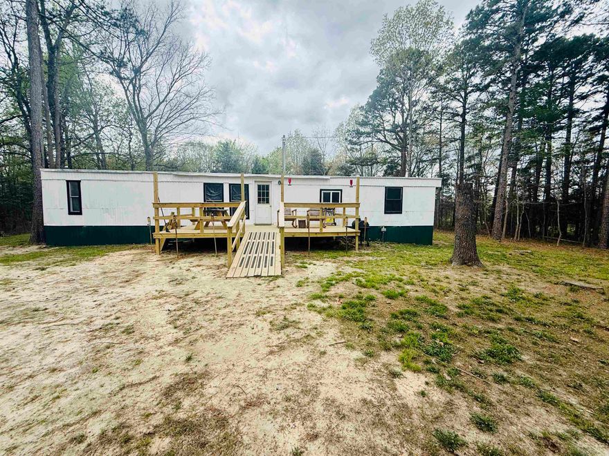 Just outside the city limits of Evening Shade! This mobile home sets on a secluded acre. Most everything has been remodeled or updated. It has city water and it's all electric. It is plumbed for propane but it's capped off. Rustic barn wood adds to the charm. New flooring throughout. All new electrical (wiring, outlets, switches & breaker box). All new plumbing from the meter and throughout the home. All new bathroom & kitchen fixtures and appliances. New stack washer/dryer. New 40 gal elec water heater. New Mini-Split heat & air. New wood-burning fireplace with a fire wall. Roof has been coated & sealed. New deck. Lumber will be left that was purchased to finish canopy over deck. Electric wall heaters installed 2019. Septic tank 9 yrs old.  Also included is a 12x24 storage building with electric. Newly planted fruit trees. There's plenty room to put in a garden or have chickens or other livestock. NAEC electric & Next internet provider. Avg utilities (water/elc) $215/month. This is a great opportunity for a cash buyer to set up a homestead. This type property is in high demand so act fast and call us today! Wildlife is spotted on the property quite often. Move-in Ready!