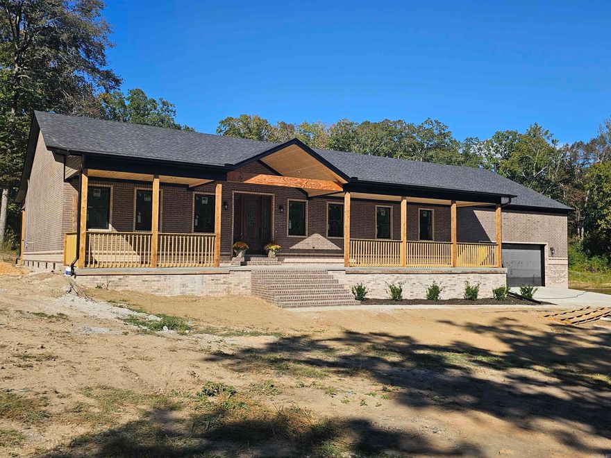 This all-brick new construction home is located outside the city limits on 4.46 level acres with a small pond. The front and back porches stretch across the house and feature tongue-and-groove wood ceilings. Inside, the open floor plan includes a spacious kitchen with abundant cabinetry, a large island, gas cooktop, wall oven with microwave, a coffee bar, and a walk-in pantry. There is also a dedicated office space. Two guest rooms are on one side of the home, and the primary suite is on the other. The primary ensuite offers two vanities, a large tiled walk-in shower, soaking tub, and two walk-in closets—one with direct access to the laundry room for convenience. The property includes a 1,200 sq ft garage and offers the peaceful setting of country living just minutes from town. See agent remarks.