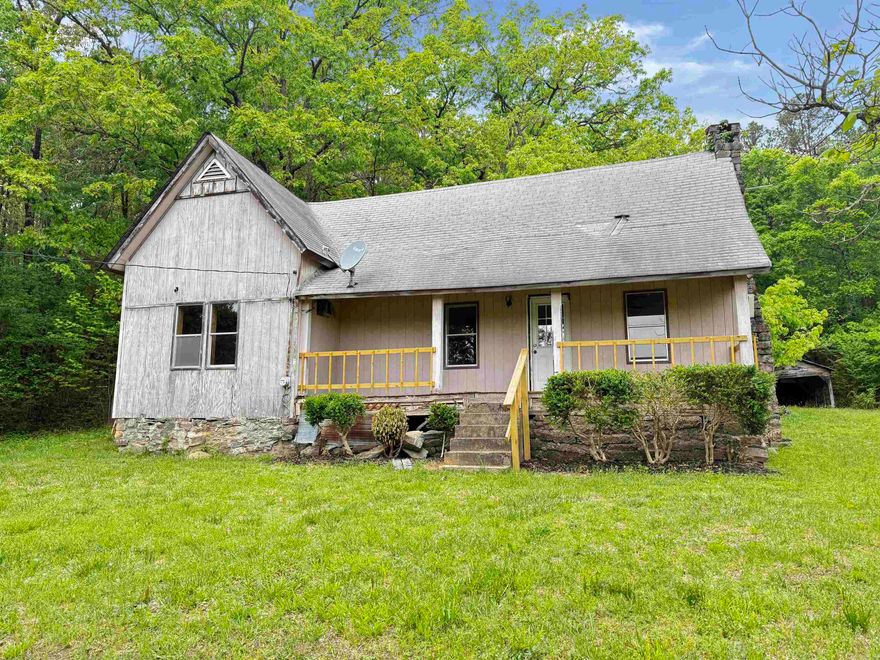 Looking for privacy and a peaceful retreat? This charming older farmhouse sits on 4.34 mostly wooded acres along a private drive, offering the perfect escape from the hustle and bustle. With over an acre cleared and ready for a garden, the property provides both seclusion and usable space. The home features 2 bedrooms, 1 bath, a spacious living area, and a separate dining room. Relax and enjoy the surrounding nature from the inviting front and back porches. Conveniently located just minutes from Hot Springs, AR,  and Lake Ouachita. This property is ideal as a full-time residence or a relaxing getaway. Being sold AS-IS.  Photos edited by Efurnished for clarity.