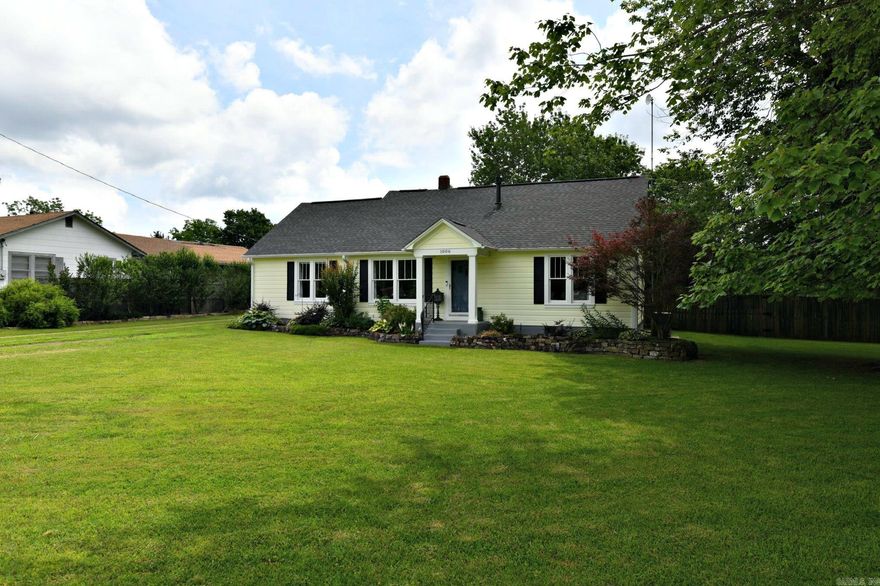 VINTAGE CHARM WITH CONTEMPORATY UPDATES  Welcome to this beautifully maintained and tastefully updated home, boasting 4 bedrooms and 2.5 baths. Built in 1965, this 1,528 square foot home perfectly combines classic charm with modern conveniences. Enjoy cooking in the gorgeous kitchen with granite countertops, ample cabinetry, and stainless steel appliances. The adjacent dining area is convenient for gatherings. The cozy living room features hardwood floors, a ceiling fan, and large windows that let in plenty of natural light. Gleaming hardwood floors extend throughout the main living areas, adding warmth and elegance to the home. The upstairs attic area offers additional living space, perfect for a home office or a play area, along with a convenient craft alcove and a half bath, could be used as a 4th bedroom or den/office. Step outside to a large deck ideal for summer barbecues and gatherings. This home is wired for a generator and includes a 30 amp RV hookup. A detached shop offers extra storage or workspace for hobbies and projects. The property features extensive landscaping, providing a serene and private outdoor space. Garden area, fire pit and large, level, fenced back yard.