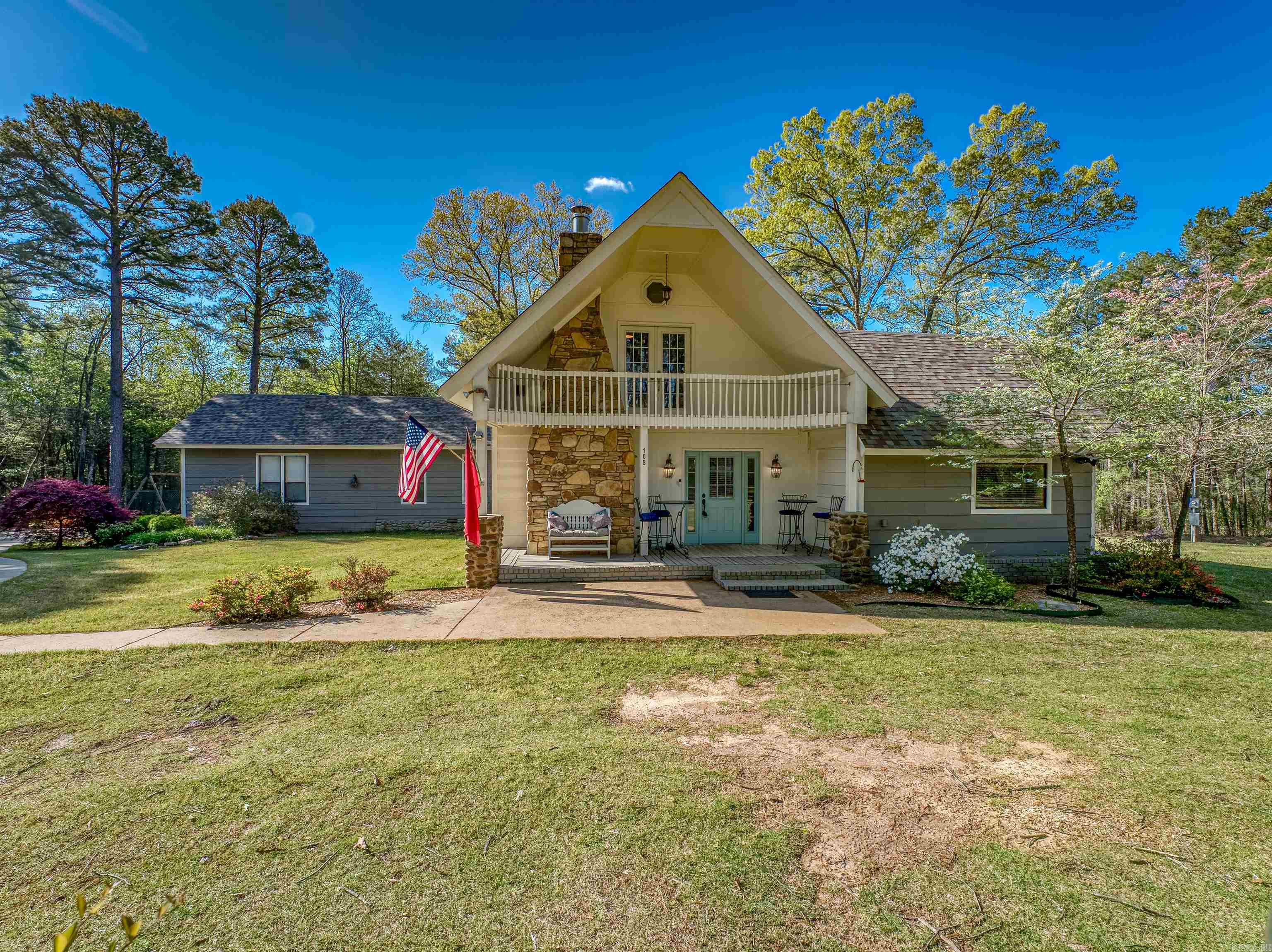 Welcome to this charming and spacious retreat nestled just a short walk to Greers Ferry Lake in the serene Ozarks! This picturesque property on two parcels offers a perfect blend of country living and modern comforts. Situated on a tranquil, partially-wooded lot, this charming residence boasts 3 bedrooms, 3 bathrooms, and ample space for both relaxation and entertaining. Enter to a bright and open floor plan that seamlessly connects the living, dining, and kitchen areas, with views of the surrounding woods and outdoor beauty through every window! The cozy front room features a stone fireplace, perfect for those chilly Arkansas evenings. Beautifully-updated kitchen has abundant storage. Two spacious, separated bedrooms with adjacent full bathrooms on the first level and one expansive bedroom with full bath and exterior balcony on the second level. THREE water heaters! Bonus/Great Room in rear of house has soaring ceilings, abundant windows, and dual ceiling fans. Gorgeous landscaping around all sides, plus yard irrigation system, backyard fire pit, and large detached shop/bonus garage building. Short walk or ride to the nearest swimming/boat ramp on the lake!