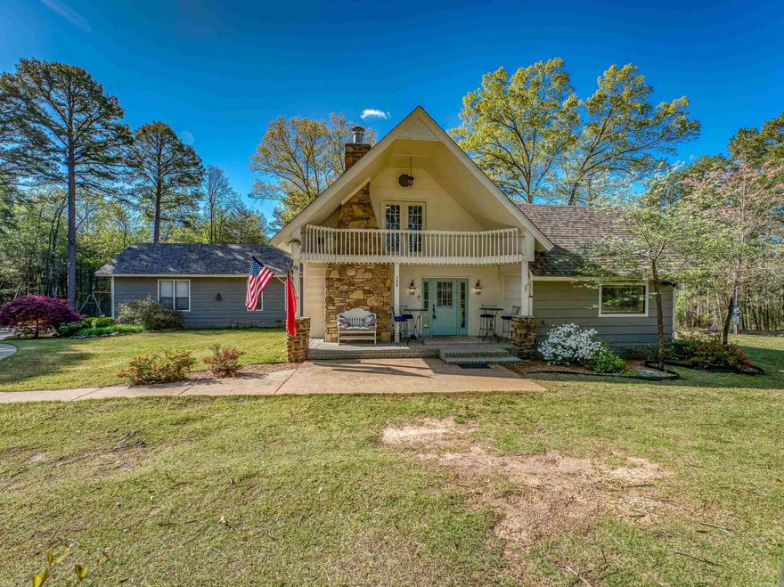 Welcome to this charming and spacious retreat nestled just a short walk to Greers Ferry Lake in the serene Ozarks! This picturesque property on two parcels offers a perfect blend of country living and modern comforts. Situated on a tranquil, partially-wooded lot, this charming residence boasts 3 bedrooms, 3 bathrooms, and ample space for both relaxation and entertaining. Enter to a bright and open floor plan that seamlessly connects the living, dining, and kitchen areas, with views of the surrounding woods and outdoor beauty through every window! The cozy front room features a stone fireplace, perfect for those chilly Arkansas evenings. Beautifully-updated kitchen has abundant storage. Two spacious, separated bedrooms with adjacent full bathrooms on the first level and one expansive bedroom with full bath and exterior balcony on the second level. THREE water heaters! Bonus/Great Room in rear of house has soaring ceilings, abundant windows, and dual ceiling fans. Gorgeous landscaping around all sides, plus yard irrigation system, backyard fire pit, and large detached shop/bonus garage building. Short walk or ride to the nearest swimming/boat ramp on the lake!