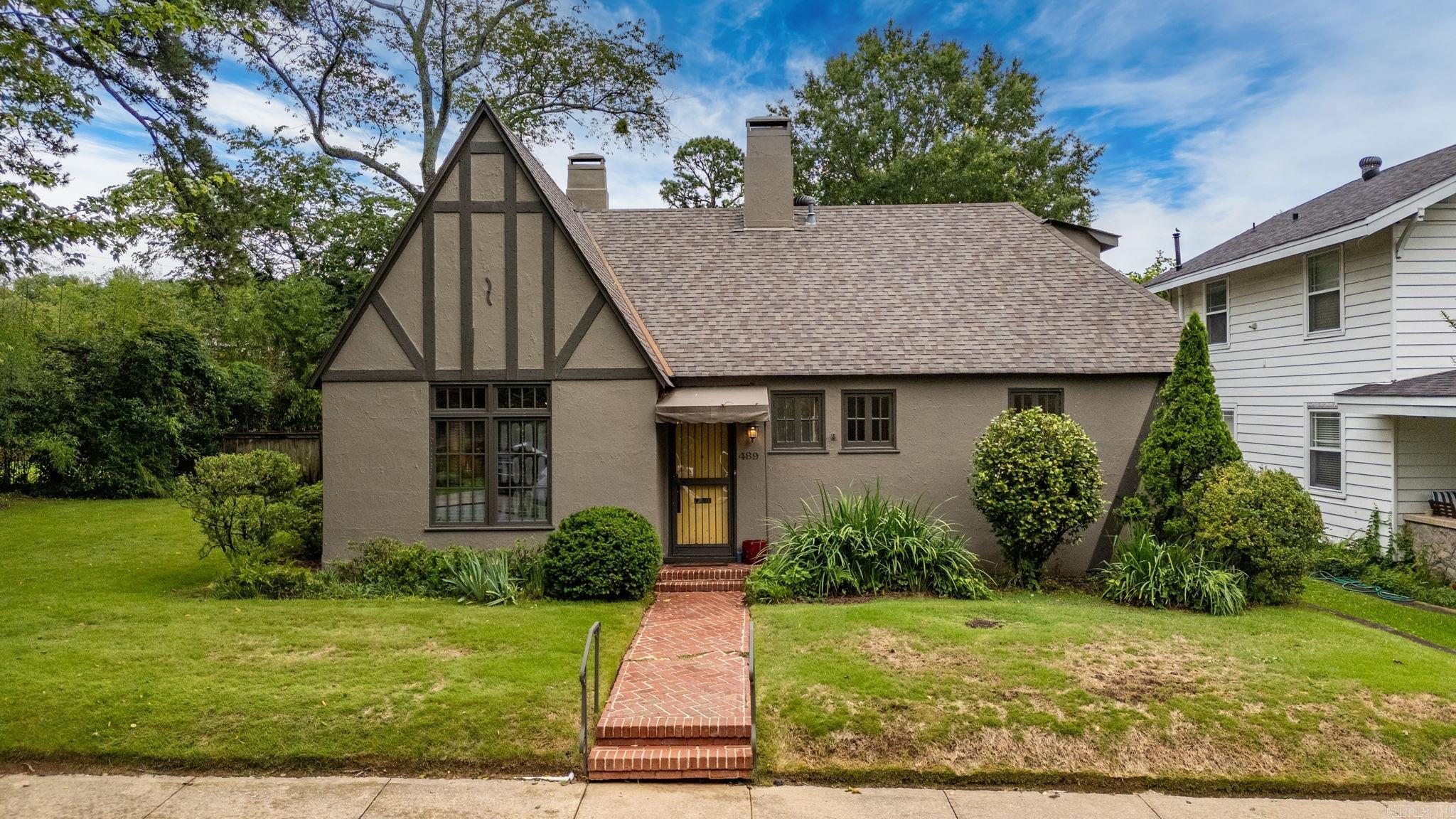 Welcome to this stunning 1921 Hillcrest Tudor Revival home on an oversized lot. This 3 bed/3 bath stucco home is unique with its half-timbering accent. Exposed heavy timber beams, hooded fireplace & window seat are the highlights of the living room. The dining room stands out with its own fireplace & built-in glass cabinetry. The open modern kitchen has concrete countertops, open shelving & built-in wine storage. The primary suite is on the main level with its own fireplace, spa-like bath with steam shower, vaulted ceilings & abundance of closet space! An additional bedroom & bath are on the main level. Upstairs is a private retreat featuring a large bedroom with built-in desk, storage, huge closet & private bath. Throughout the home are beautiful original windows and tongue & groove wood floors. There is an airy sunroom with its own fireplace that leads out to a private concrete patio. Above the 2-car garage that is open to the yard, sits a lovely studio apartment that could be used as a rental. It boasts its own alley entrance with stairs leading up to the 1bed/1 bath, living space, open kitchen, laundry & balcony. This home is truly unbelievable-come see this Hillcrest gem!