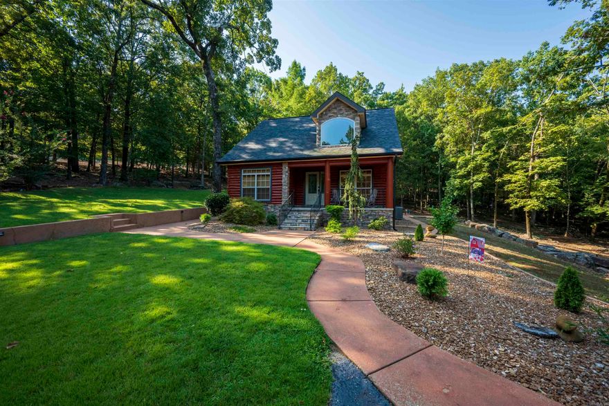 TWO PROPERTIES. TWO SEPARATE ENTRANCES. ACREAGE. 30x40 SHOP.  A DREAMY, ONE-OF-A-KIND PROPERTY THAT RARELY BECOMES AVAILABLE.  Set on 12.86 m/l acres, offering privacy, flexibility, and a layout designed for multiple living and income opportunities. The stunning log home (est. 1,827 sq ft, built 2006) features 2 bedrooms, 2 bathrooms, a spacious den/flex room, soaring ceilings, tall windows, and a beautifully designed kitchen with stainless steel appliances. Recent updates include newer shingles (2024), energy-efficient HVAC systems, freshly re-stained logs (2025), exterior drainage improvements, 400-amp underground electrical service, and beautiful curb appeal.  The second residence (est. 861 sq ft) offers 2 bedrooms, 1 bathroom, mini-split systems, all appliances conveying, and its own private driveway. Ideal for a mother-in-law suite, guest house, multi-generational living, long-term rental, or short-term rental such as Airbnb or VRBO.  Additional features include a heated and cooled 30x40 shop with half bath, soundproofing, and floor drains, a 2-car garage with storage, plus gravel parking/equipment area. A rare blend of space, functionality, and opportunity.