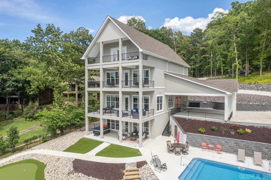 Introducing one of the top vacation rentals on Lake Hamilton. This 8 Bedroom 9 Bathroom retreat is nestled within a secluded oasis. Thisextraordinary property offers an unparalleled experience of indulgence and relaxation. The expansive living spaces are thoughtfullydesigned to blend sophistication with comfort, providing an inviting atmosphere for both relaxation and entertainment. Step outside intothe breathtaking outdoor area, where a private pool awaits. Surrounded by lush landscaping, the pool area offers a serene retreat,perfect for basking in the sun or taking refreshing dips in the crystal-clear waters. The interior of this luxury retreat boasts an array oflavish amenities. The chef-inspired kitchen is a culinary masterpiece, featuring top-of-the-line appliances, premium finishes, and amplecounter space. This exceptional luxury vacation rental with a pool is an embodiment of refined living, offering an unparalleledcombination of elegance, comfort, and leisure. Whether you seek a serene retreat or a magnificent venue for hosting grand gatherings,this property is a true masterpiece and the most coveted investment property on Lake Hamilton.