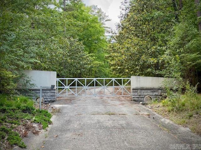 Discover a unique opportunity on 16.65 +/- acres of tranquility, just minutes from Crystal Springs marina. A 2023 fire impacted the home's center, but much of the structure, landscaping, and unique features remain salvageable. The property includes two landscaped ponds, one with a waterfall and grotto, concrete constructions, a heated pool, two water wells, two septic tanks, and a buried 1000-gallon propane tank for dual home generators. Underground utilities, a concrete driveway with curb and gutters, a custom electric gate, and anew shop, and much more. This property offers endless potential for restoration and customization.