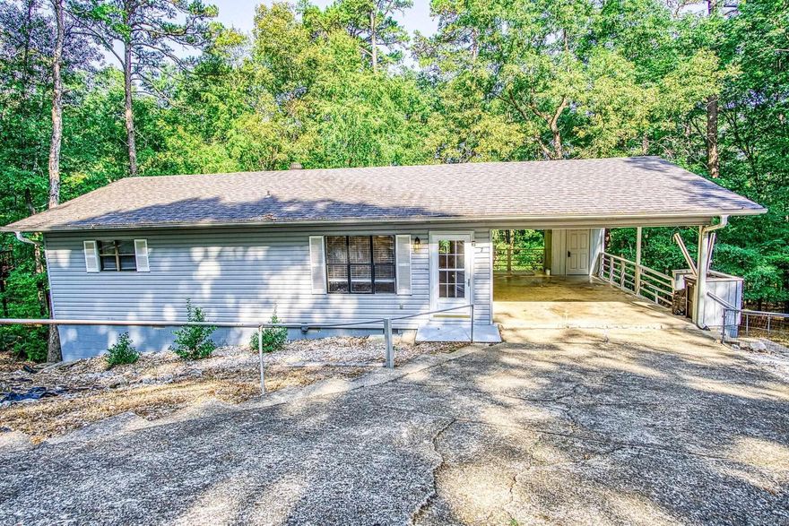 The paint is barely dry....Freshly painted inside and out. Conveniently located 2 bedroom 2 bath home. This has been an investment property for the last 2 owners. Open floor plan, easy care exterior and fenced yard. Laminate flooring. Guest bath offers step in shower. Open floor plan creates great room for living and dining areas. Single carport with additional storage closet. Located at the back of the culdesac so you have acres of quiet common property adjoining your fenced back yard. Convenient short drive to shopping amenities and restaurants of Hwy 7 N. Hot Springs Village Property Owner Association has a $1500.00 buy-in fee for new members due and collected at closing.