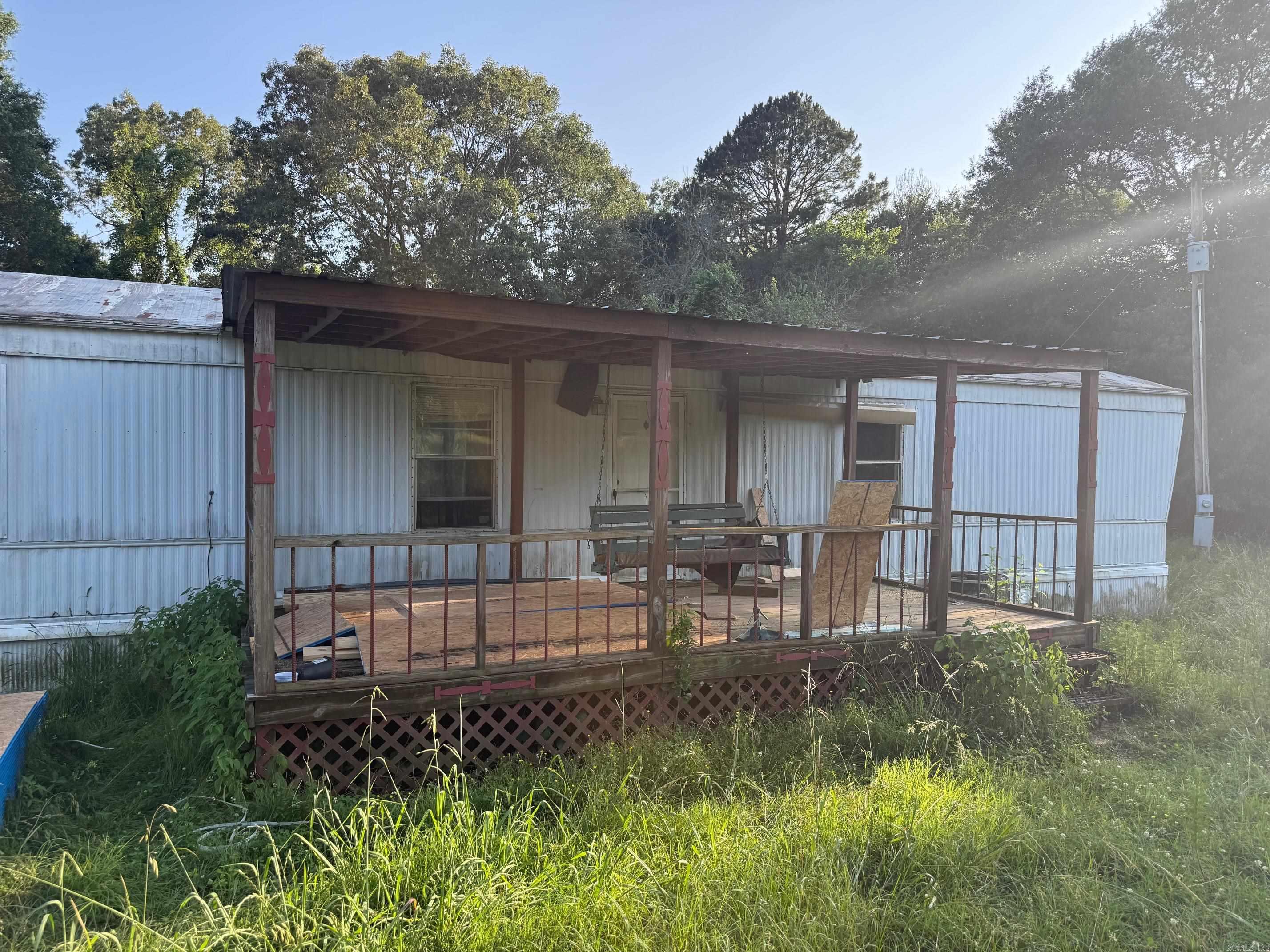2 Bedroom / 2 Bath Mobile Home with some remodeling done. Home is still in need of flooring and some other repairs. This nice 20 acre Property has some fencing and a metal pipe corral. There is a Shop building and a couple of other outbuildings that can be used for storage. There also is another spot that has water, electric and sewer for another trailer hookup. This Property is part Woods and part Pasture for the Livestock. This Property is located on a paved road just 1/4 mile from Hwy 71, 18 miles to Mena but only 5 miles to the National Forest which can be accessed by ATV. Great starter Property!