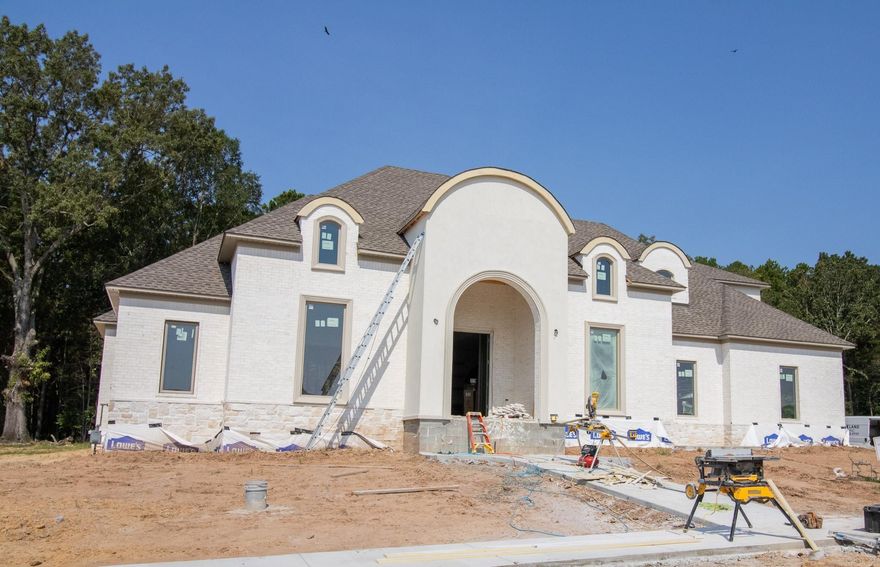 Stunning new construction custom home with luxury tile finishes, custom trim and cabinetry throughout, and gorgeous exterior finishes!