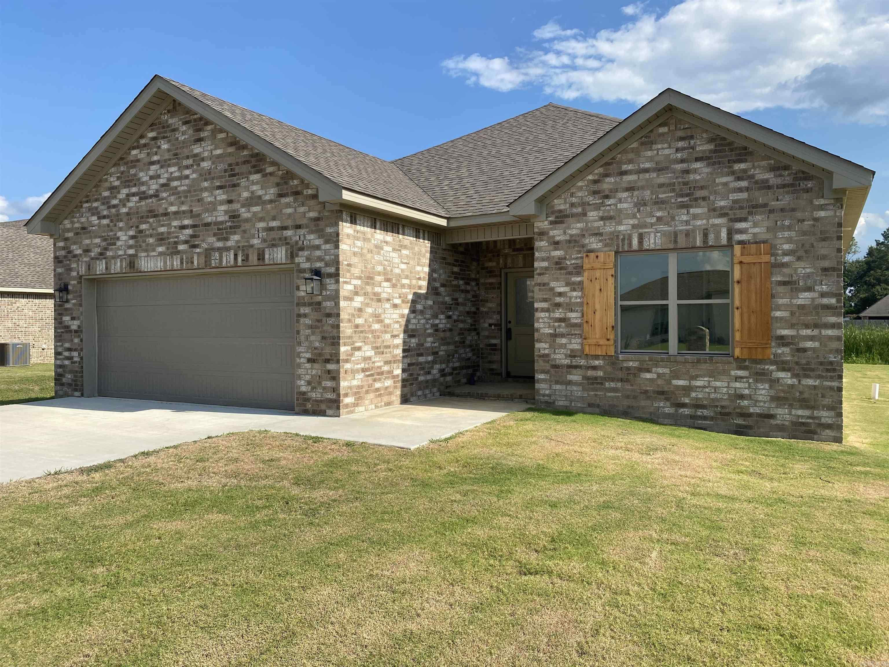 What are you waiting for? Come tour this Lovely, brick new construction home with 3 bedrooms and 2 bathrooms. Open plan with raised ceiling in the living room which overlooks the covered back patio and backyard. The kitchen is open to the living/dining and has a fantastic island and pantry. The Primary Suite contains a separate tiled shower and deep soaking tub. The two secondary bedrooms have entrances separate from one another, allowing for a little more privacy.