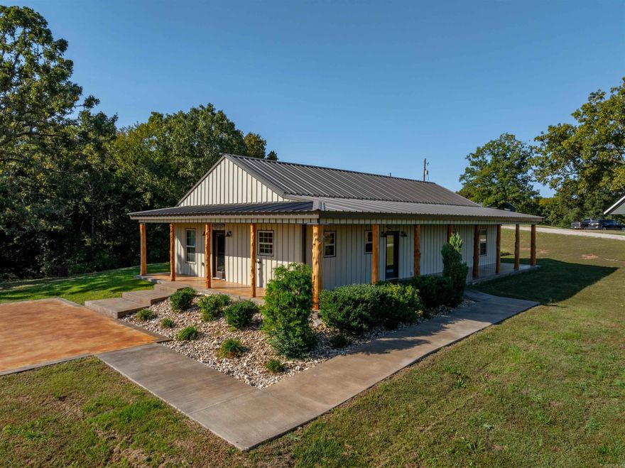 Perched atop a hill on over 2 acres, this unique property offers both stunning views and thoughtful features.A spacious shop includes two rollup doors, concrete floors, and electricity throughout, with lighting and a side door for convenience.Off to the side, you'll find a large chain-link fenced area perfect for your pets.The entrance welcomes you with a concrete slab, beautifully landscaped grounds, and wheelchair accessibility.The wrap-around porch, featuring rustic cedar posts, metal roofing, and metal siding, ensures low maintenance and adds to the charm.Inside, the open-concept living area boasts an electric fireplace with a mantle across the top—ideal for hanging stockings—and a TV mount already in place.The kitchen is a chef’s dream, equipped with top-of-the-line appliances: a Bosch dishwasher, Saba refrigerator, and a six-burner Zlone professional gas cookstove paired with a large NXR vent hood. Shaker cabinets, custom granite countertops, and a bar that comfortably seats four or more complete the space.The wood ceilings and industrial touches, like exposed piping for hanging shelves, blend perfectly with the farmhouse aesthetic.3 Large bedrooms, Large walk-in Shower.