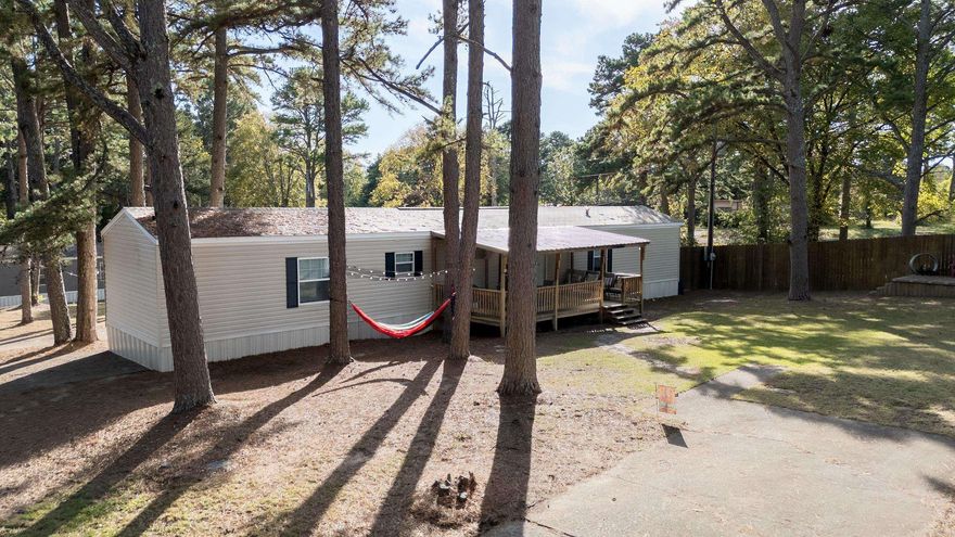 Sitting on three lots. This Immaculate 3-bedroom, 2-bath home featuring an inviting open-concept floor plan and a spacious kitchen perfect for gatherings. The primary suite offers a relaxing retreat with a walk-in shower, soaker tub, and double vanity. Enjoy the outdoors on the covered front porch or entertain guests on the large deck. Home is partially fenced for additional privacy Located just minutes from Fairfield Bay’s lake, marina, golf courses, and local amenities, this move-in ready home truly has it all. Don’t wait—this one won’t last long! Call today to schedule your personal tour.