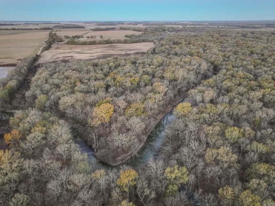 Flooding Timber and Habitat on the L'Anguille River.  In the heart of the Missisippi flyway, this  Arkansas delta property has +/-5,000 Ft. of the L'Anguille River passing through it-providing an ideal scenario for attracting waterfowl.  With +/-150 acres of mature oaks, other hardwoods and brush, that flood naturally depending on the L'Anguille River levels, this property has the natural foundation to build your hunting retreat.  Flat contours, slow to drains soils, and multiple depressions provide the opportunity to incorporate water control structures throughout the property to maintain water in the timber and brush areas.    +/-69 AC of fields-formerly used to grow rice-are adjacent to the River and standing timber and could be flooded using the current well.  The area is surrounded by properties in conservation easements and is near public use areas.  As such, it is likely a strong candidate for its own conservation easement.  Moments from I-40 and Palestine, this property is convenient to Memphis, Little Rock and the rest of the world.  Act today, habitat like this is in short supply!
