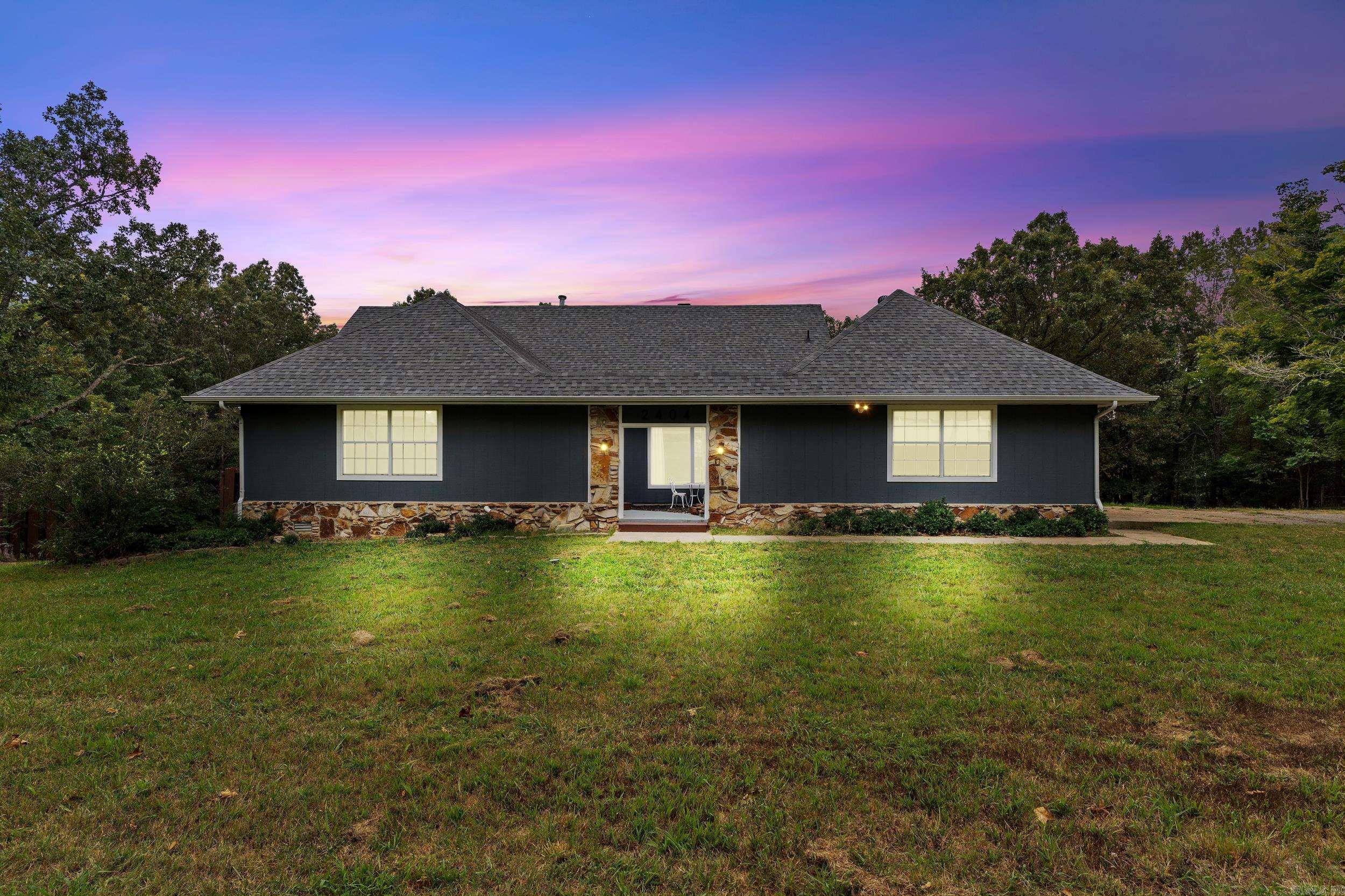 Completely renovated 5 bed, 2.5 bath, three-level home on 2.5 acres just outside city limits. Features include a dual-sided fireplace, stainless appliances, updated cabinetry, and sliding doors to a covered wraparound deck with scenic views. Multiple living spaces include a family room, dining room with waterfall courtyard view, and a lower-level great room with kitchenette and private entranceāideal for guests or multi-gen living. Layout offers 2 beds/1 bath on the main level, 2 beds/1 bath upstairs, plus 2 bonus rooms downstairs. Updates include new flooring, lighting, waterproofed basement, water filtration, water softener, and gutters. With no restrictions, ample parking, and a move-in ready interior, this property is perfect for families, entertaining, or quiet country living just minutes from restaurants, shopping, and medical facilities.