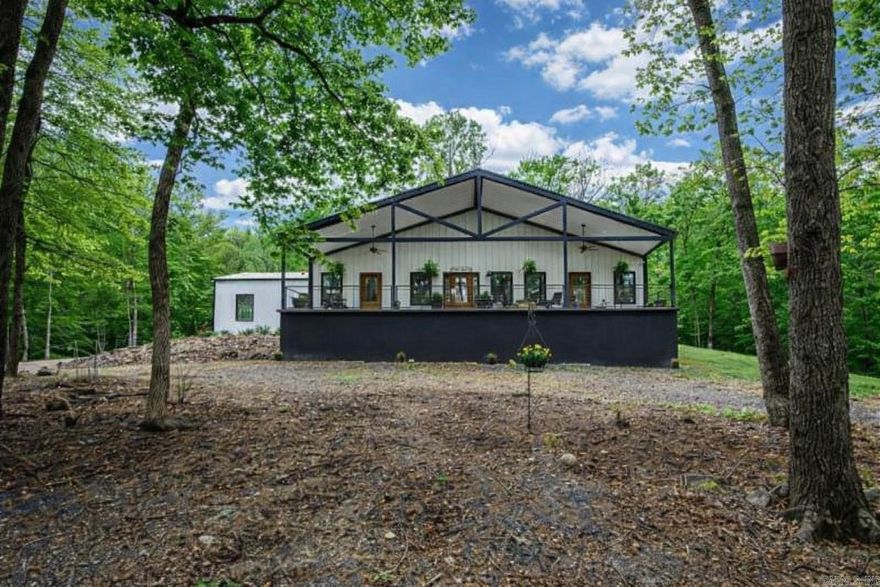 Discover your own private retreat in the heart of the Ouachita Mountains. This exceptional 10.93-acre property offers the perfect blend of comfort, functionality, and natural beauty, bordered by National Forest land for added privacy and endless outdoor opportunities.The 1,668 sq ft barndominium built in 2023 features 3 bedrooms and 2 bathrooms, designed for low-maintenance living without sacrificing comfort. A whole-house generator and water filtration system provide peace of mind and convenience year-round. Step outside and enjoy the sights and sounds of nature, with a pond, natural spring, and year-round creek flowing through the property. Wildlife is abundant, making this an ideal setting for nature lovers, hunters, or anyone seeking tranquility. This property is well-equipped for work and recreation, featuring a 40x40 metal shop, a 26x32 wooden shop, and three RV hookups—perfect for guests, rental potential, or extended stays. Located just minutes from Mena, you’ll enjoy both seclusion and accessibility. Seasonal mountain views add to the charm, making this a truly special place to call home, vacation, or invest.