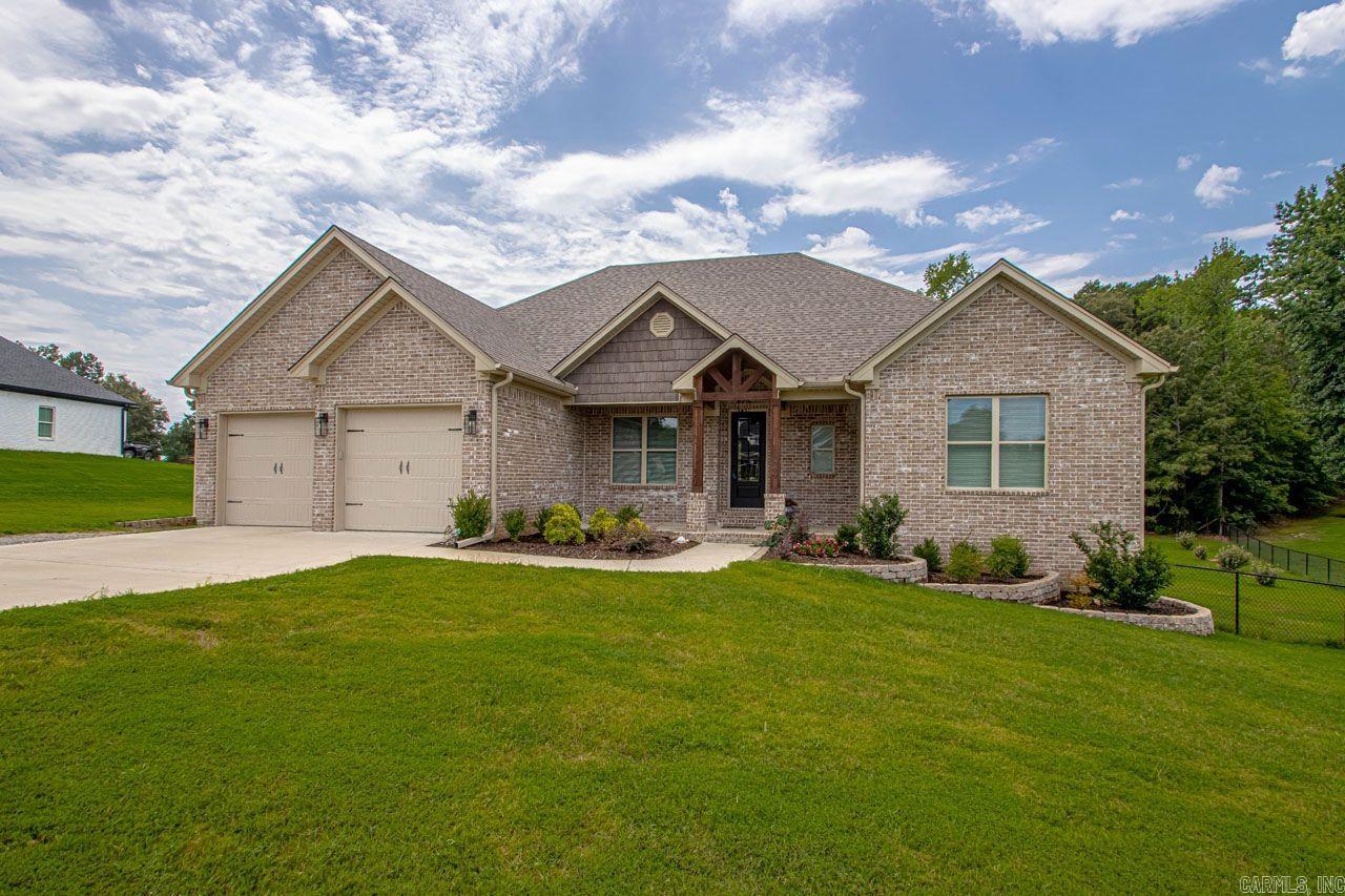 Gorgeous and spacious living in the country! This amazing 4BR 2.5 BA all brick home built in 2021 sits on a beautiful acre of land. Decorator touches throughout! LVP flooring in living areas, formal dining area, huge master bath & closet, big pantry, fireplace, great open floor plan. Exterior features a 2 car garage, deck out back, fully fenced backyard, fruit trees, & massive 40 X 30 heated & cooled work shop! Bryant Schools! Easy to show!