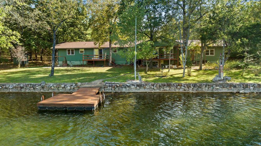 You don’t come across lake homes like this very often.  Tucked away at the end of a quiet cul-de-sac in Cherokee Village, this property sits on approximately 0.9± acres across multiple lots—offering level ground, true privacy, and a setting that feels calm the moment you arrive.  The view is the first thing that grabs you… and it never lets go. From the main living areas to the outdoor spaces, this home was designed to take full advantage of the water, creating a natural flow for both quiet mornings and meaningful gatherings.  The one of the primary suite is where this home truly sets itself apart—privately positioned with its own covered deck overlooking the lake. It’s more than just a bedroom… it’s a place to slow down, breathe, and take in the stillness of the water at the start and end of each day.  The lower level offers flexible space for guests or hobbies, and the 3-car garage provides room for everything that comes with lake living.  Private. Peaceful. Hard to find. This is the kind of property people wait for—and don’t want to miss.
