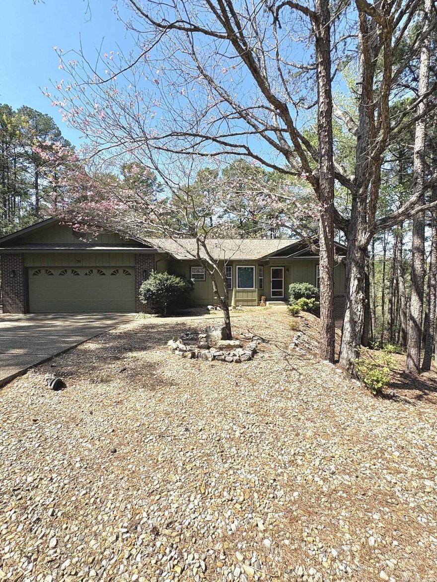 Privacy & Seclusion with Modern Updates! This 3-bedroom, 2-bath home offers a peaceful setting with a level driveway and lot, plus a secluded backyard filled with wildlife. Inside, enjoy a split floor plan with vaulted ceilings, hardwood flooring, fresh paint, and new carpet in the bedrooms. The kitchen features a new range and microwave, and all appliances convey for added convenience. A cozy, heated and cooled sunroom with walls of windows provides year-round enjoyment. Step outside to a newly remodeled multi-level back deck—perfect for relaxing or entertaining. Additional features include a workshop in the garage and a walkout basement with ample storage that could be finished to create additional living space. Conveniently located near Coronado Lake, boat ramp, Coronado Fitness Center, trails, Coronado Event Center and Library, with easy access to multiple gates thanks to its central location.