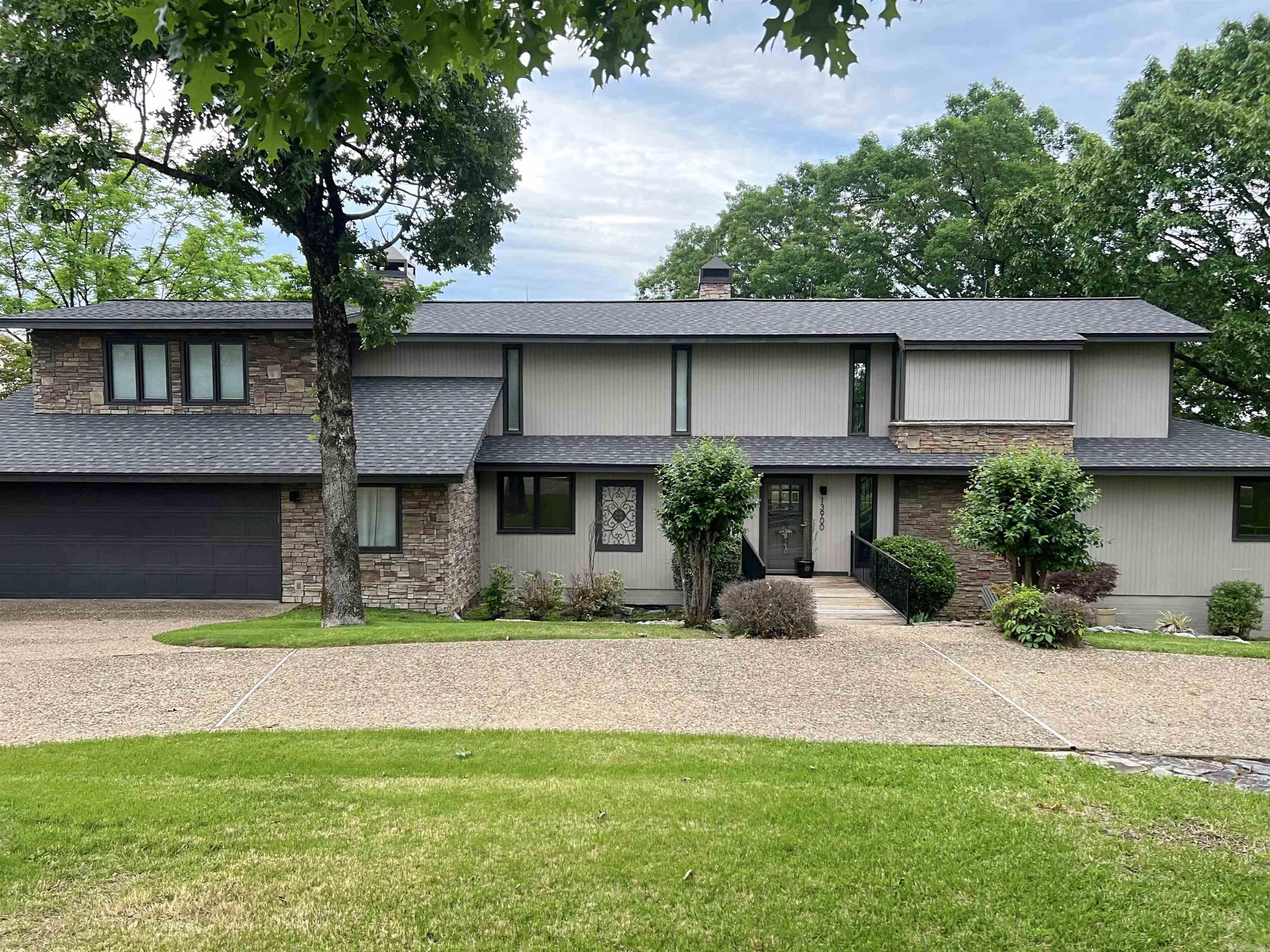 Welcome to 13900 Rivercrest Dr., where luxury meets tranquility in Little Rock! This stunning 4-bedroom, 2.5-bathroom home presents impeccable features and breathtaking views of the Arkansas River. Step into the kitchen, just off the main entry, adorned with sleek granite countertops, and stainless steel appliances. Unwind in the spacious master suite, featuring an updated bathroom, sprawling walk-in closet, rock fireplace, and a private balcony overlooking the serene river landscape! The 2 additional fireplaces on the primary level allow you to set the perfect mood throughout the house on the cooler nights. Entertain guests in style with a dry bar off the kitchen and a dining area, offering panoramic river views through its expansive glass wall! With the sizable master suite and additional bedroom upstairs, as well as two bedrooms and a full bathroom and living area/den on the bottom level, this home offers ample space and versatility. Outside, a large fenced yard and deck running the length of the house beckon for outdoor gatherings, or peaceful evenings enjoying the view. You will find the neighborhood extremely walk/bike friendly, with bike lanes all around! Enjoy easy access t