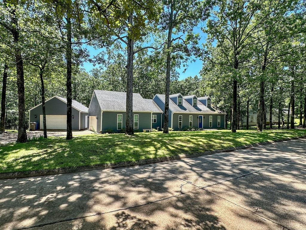 Nestled on over half an acre, this beautifully maintained 4-bedroom, 3-bath home offers a blend of custom features & everyday comforts. The heart of the home is a stunning custom kitchen, complete with double ovens, a pot filler, under-cabinet lighting, built-in spice storage with sliding shelves, elegant granite countertops — perfect for the home chef. Enjoy hardwood & tile flooring throughout most of the home, along with stylish crown molding downstairs. The primary suite features a walk-in closet & a bathroom with a jetted tub & separate shower. Guests will appreciate the stylish downstairs hall bath with its custom tiled tub surround. Three of the four bedrooms have walk-in closets so you will appreciate all the storage. Step outside to a large covered deck overlooking the tranquil, tree-lined backyard — an ideal spot for morning coffee or entertaining. The property also includes a 24x26 workshop, sprinkler system, & exterior video surveillance for added peace of mind. Energy efficient windows have been recently installed. Located on a quiet, picturesque street, this home offers comfort, character, & convenience — truly a rare find!