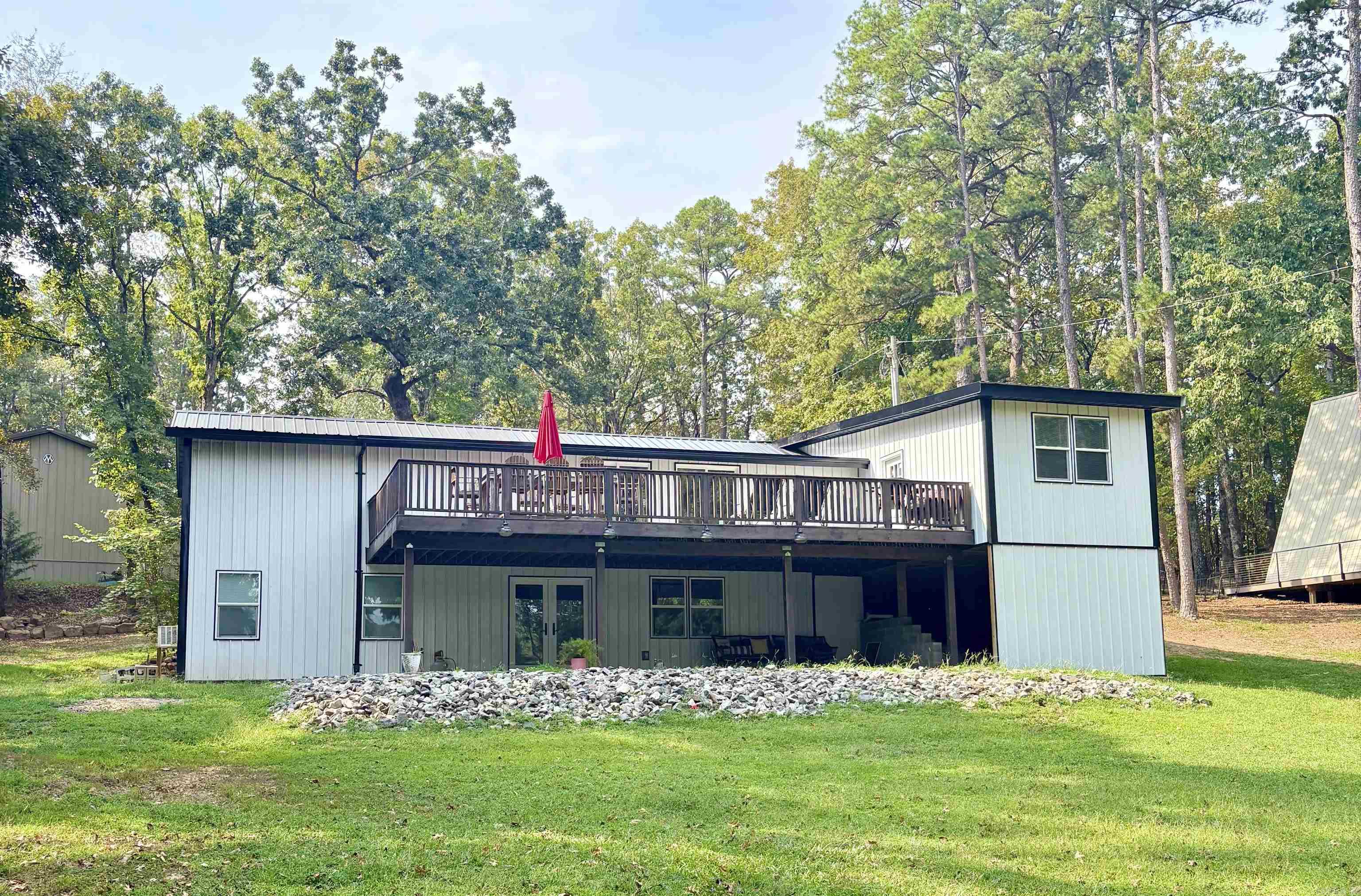 Uncover your lakeside retreat with this 3-bed, 2 bath home on 1.24 acres! Enjoy a new room (June 2025), updated upstairs flooring (April 2025) and bonus living area downstairs! Relax or the deck or on the lower patio, either one is perfect for entertain. The 40x36 shop with electric and rough in plumbing is ready for any project, and a 1 slip personal dock offers instant lake access. Secluded yet still close to town, this is an AS IS sale, with motivated sellers!