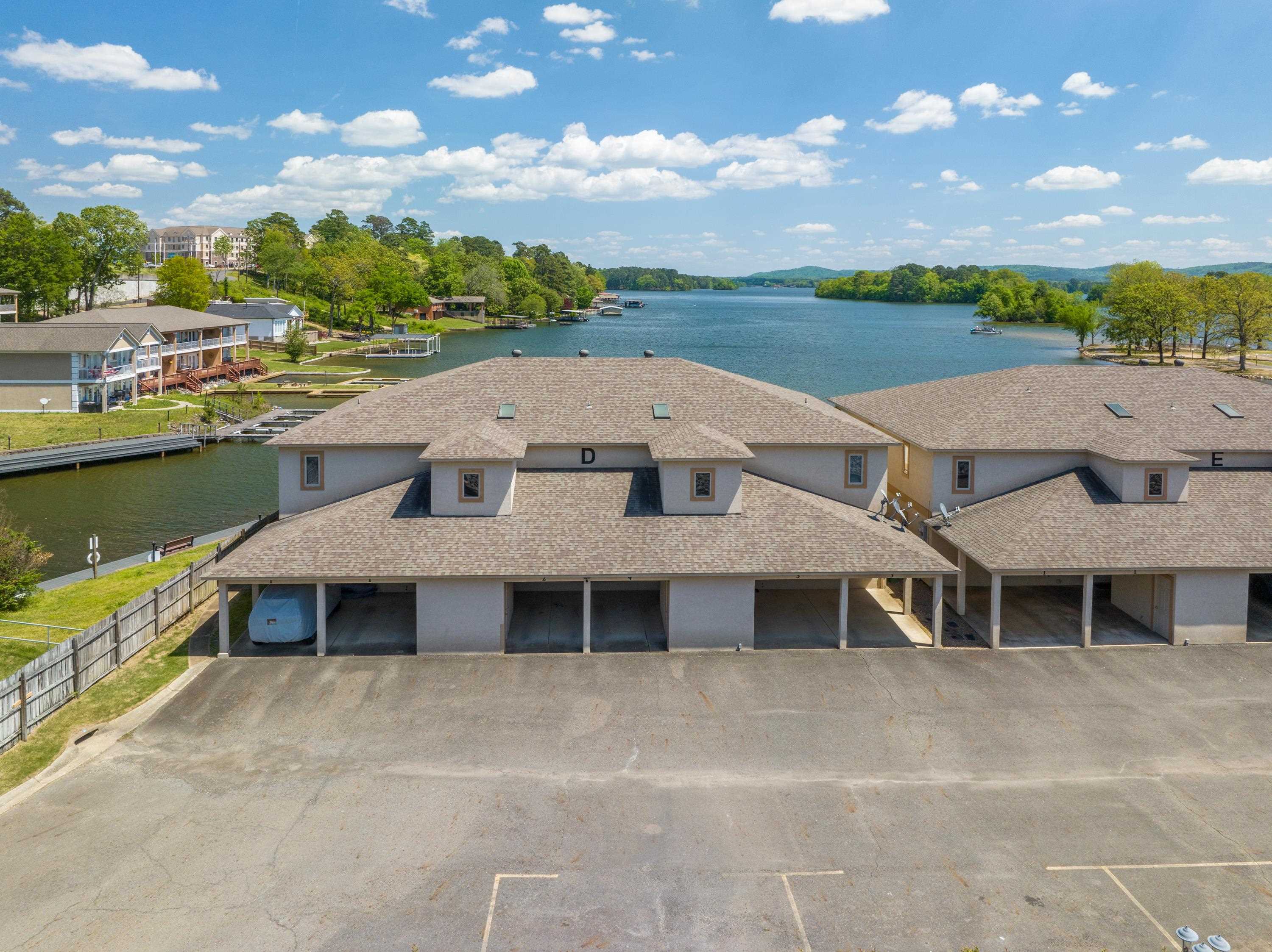 ON THE LAKE! This stylish place to stay is perfect for couples or families. 2Br/2Ba WITH A BOAT SLIP. The Vibe is located in the popular 7 South area, right off of Central Ave. Walk right out the back door and out to beautiful Lake Hamilton. Walk right in to this ground level 1500 sf condo with 2 private covered parking spaces and a private boat slip. Open, modern and fully-stocked with high end furniture, luxury linens, and comfortable mattresses. King size beds in both bedrooms with another fold out bed with memory foam mattress. The kitchen is fully stocked and ready, an electric grill on back porch with cooking utensils. Laundry features a full-size washer and dryer,. This property is lakefront allowing you to swim, fish, paddle board, canoe, or kayak right outside the back door. Currently operated as a successful short-term rental.