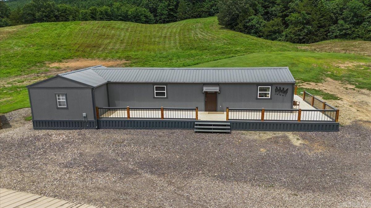 Come explore all the possibilities this property has to offer. This 1025 SF Home sits on 15 acres with a great little 12X12 She Shed for her crafting and projects. This little building has A/C and a covered porch. The larger metal building is a 1700 SF workshop for him featuring a concrete slab and is fully insulated with electric and plumbing. Shop has a bathroom that has a separate septic than the house. This shop has the potential to be built out into a great Barndominium for the enthusiast who wants that Barndo style living. This home has been thoughtfully put together to meet your needs with low maintenance and easy living. This 2-bedroom 1 bath would be your perfect starter home to increase as your family grows. The 15 acres feature some cleared pasture land as well as a few wooded acres with a pond. The property will offer you privacy and plenty of space. This location joins property that is a designated hunting lease that will give you acces to thousand of acres. You can join the hunting lease and enjoy a hunters paradise. Come do some homesteading and explore your options as this opportunity knocks. This is a great property offering lots of value and ready for you!
