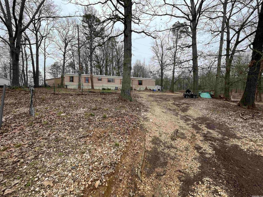 Sold AS-IS, fixer upper. This three bedroom two bath single wide trailer seats on 2.65 acres of land. The top part of the land is fenced in and set up for horses already. If your looking for rural living but close enough to plenty of amenities this is perfect for you.  All appliances and sheds will convey.